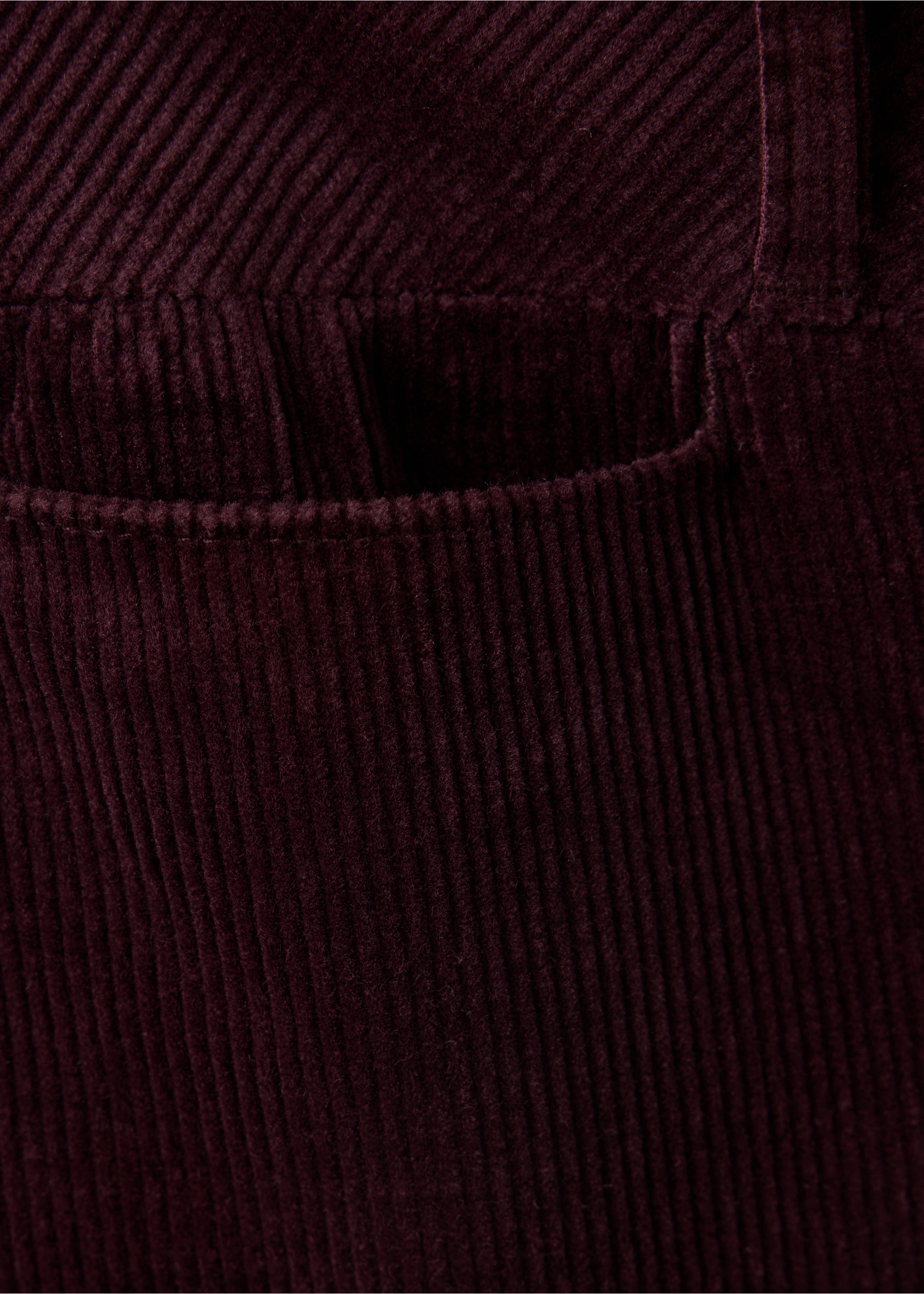 Burgundy corduroy trousers fabric detail showing texture and pocket., Wine. Ref: 47031428-00.