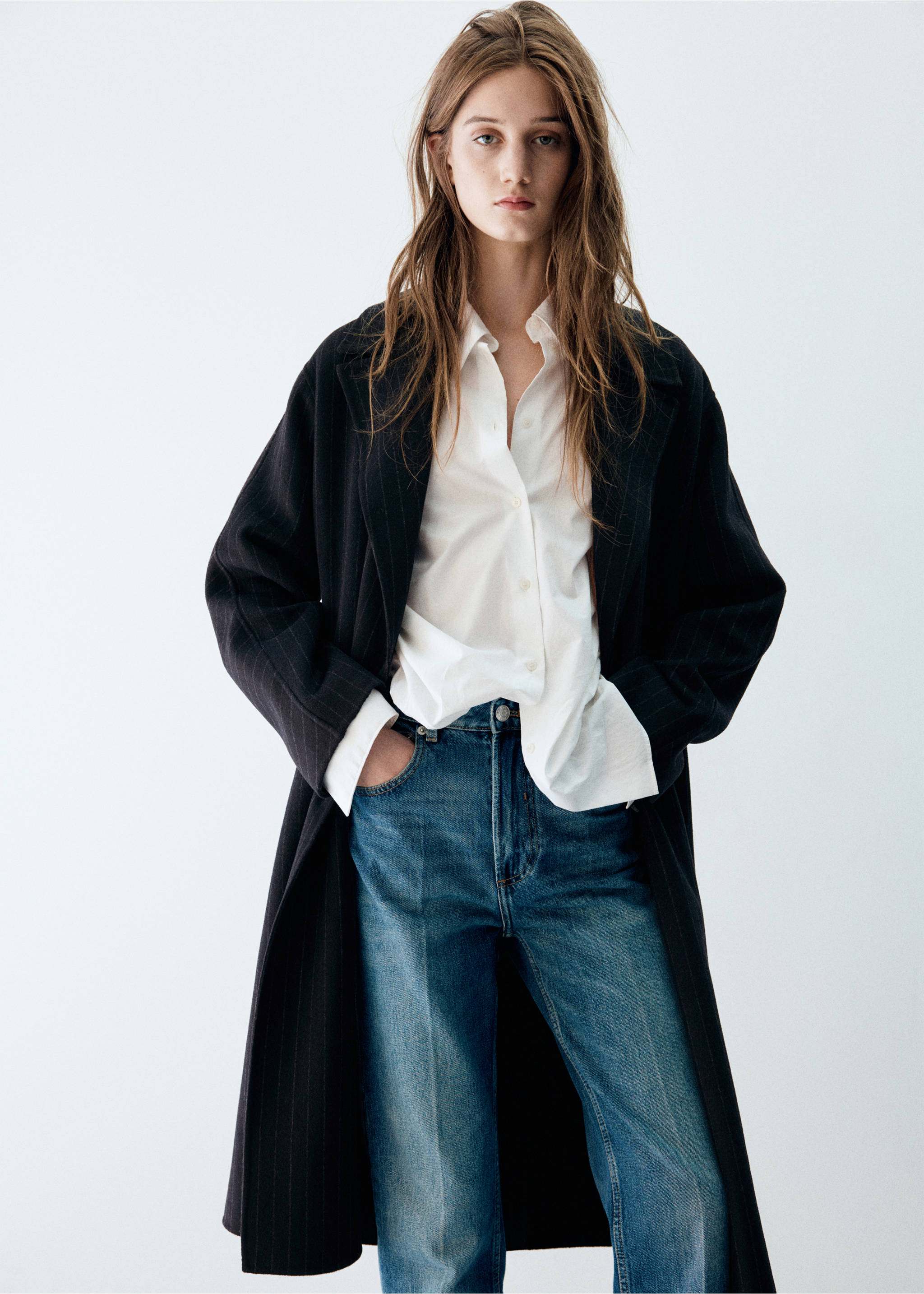 Black pinstripe long coat worn over a white shirt and blue jeans., Navy. Ref: 47031454-00.