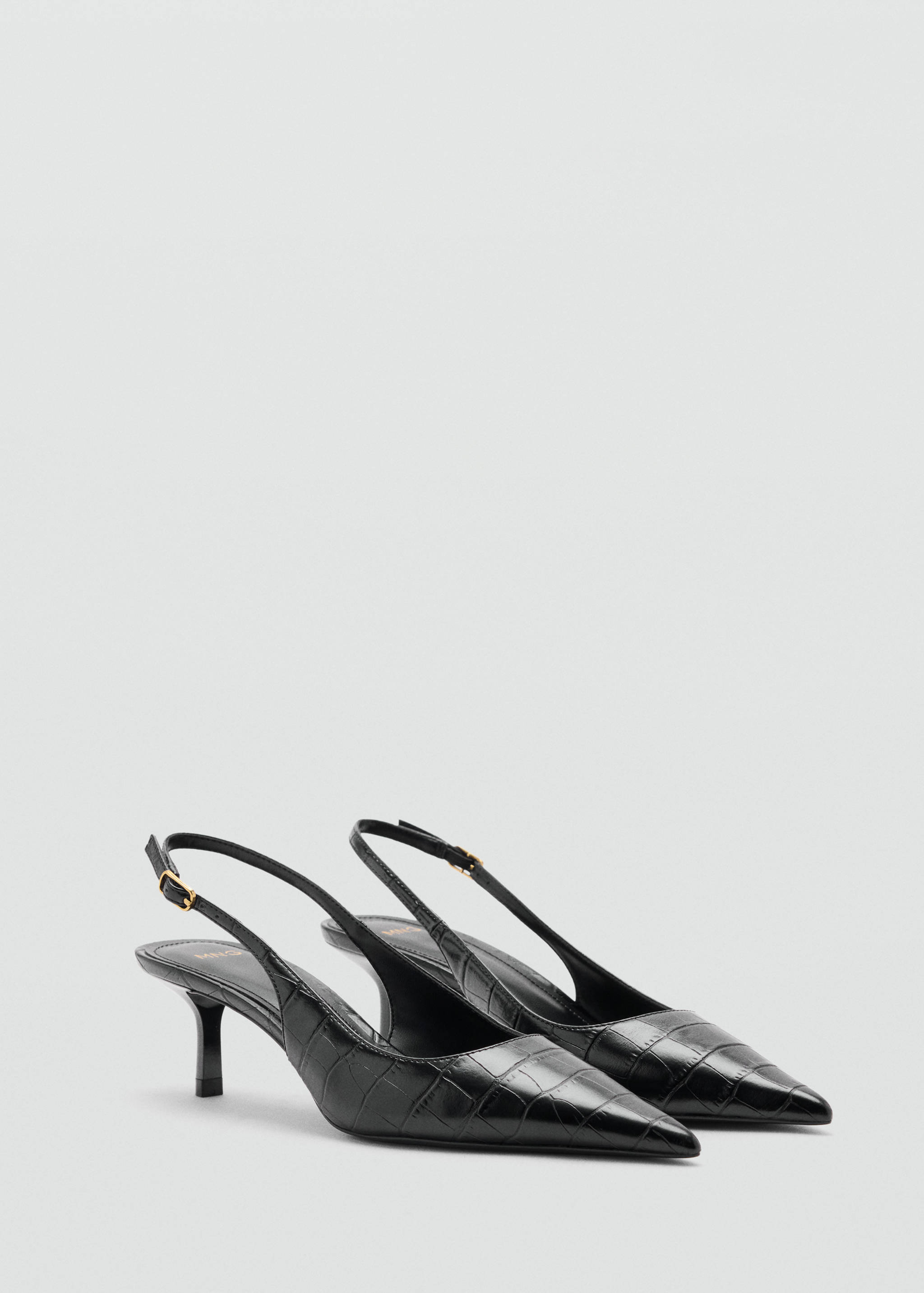 Black embossed slingback shoes with pointed toes and kitten heels.