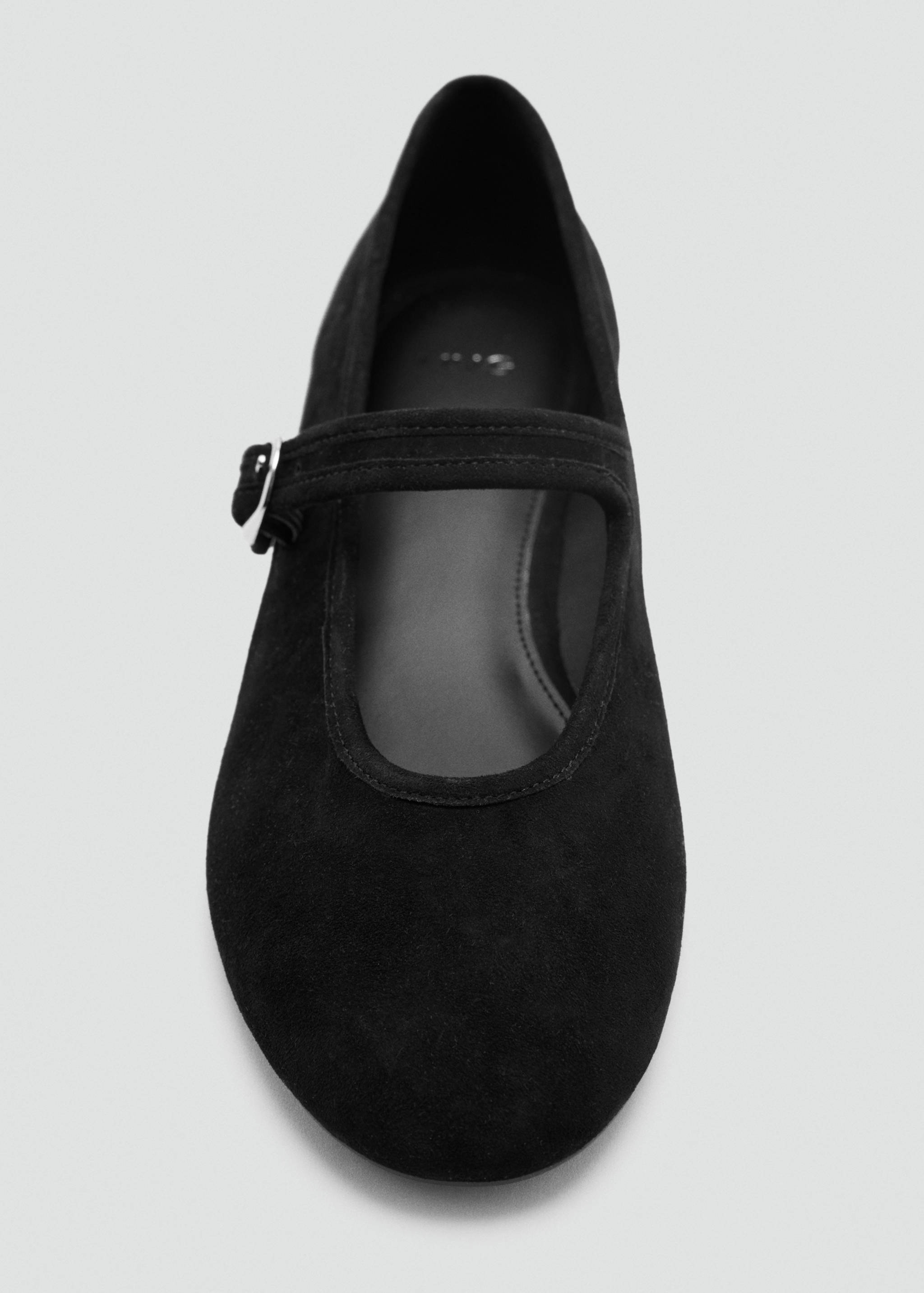 Black Mary Jane shoe with a rounded toe and buckled strap.