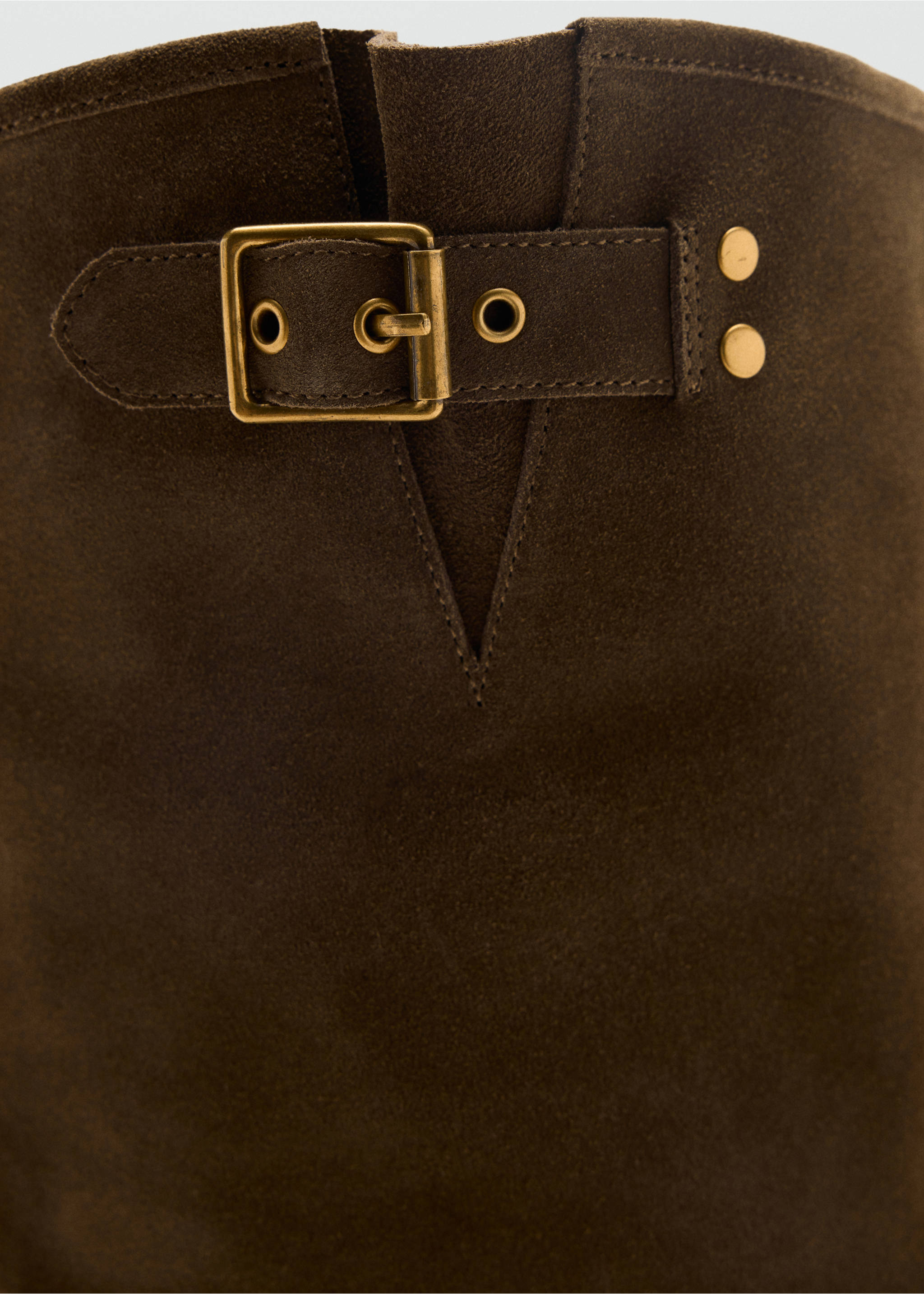 Close-up of a dark brown suede boot shaft featuring a buckled strap with antique brass hardware., Medium Brown. Ref: 47041337-00.