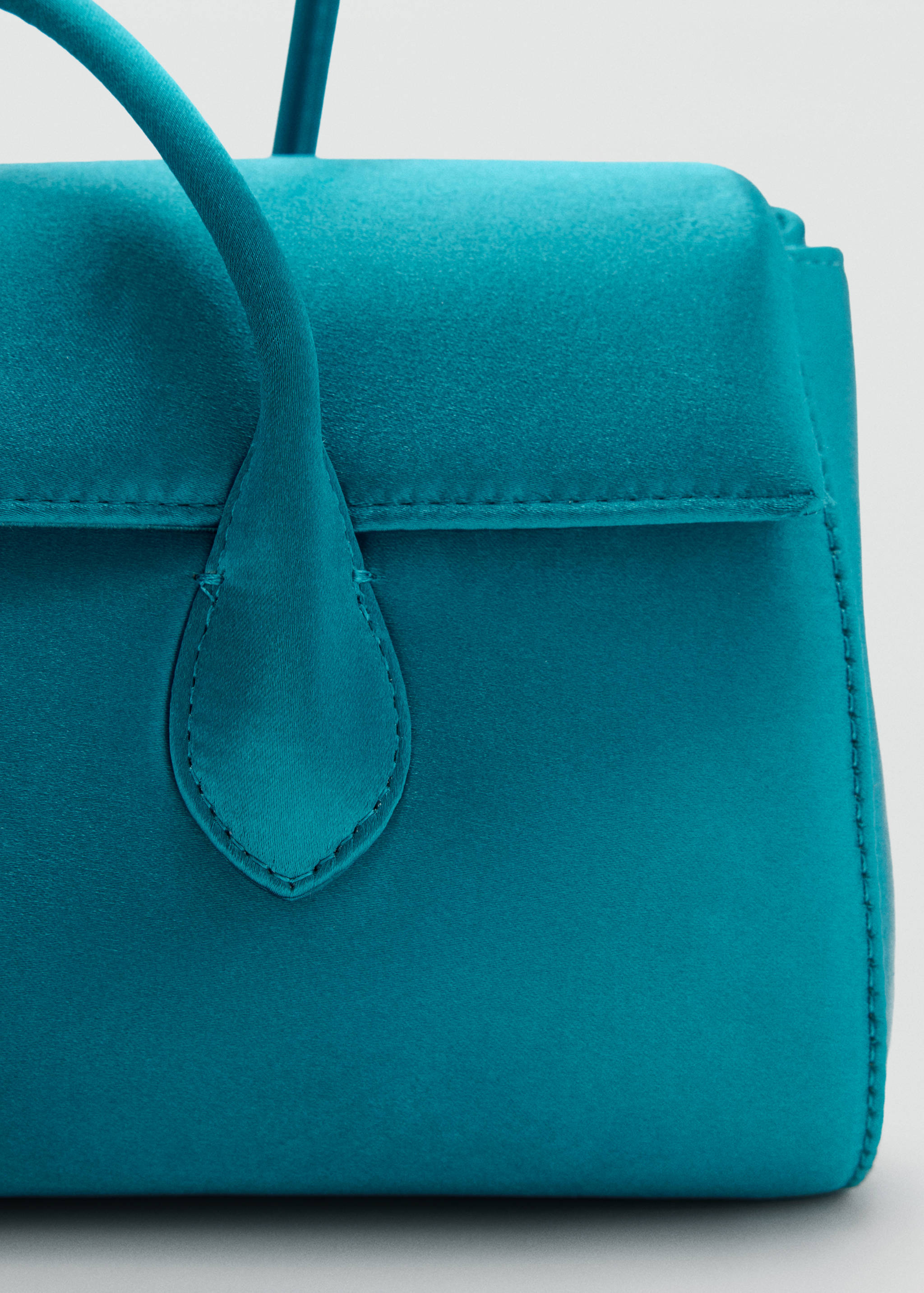 Teal satin shoulder bag close-up showing flap detail