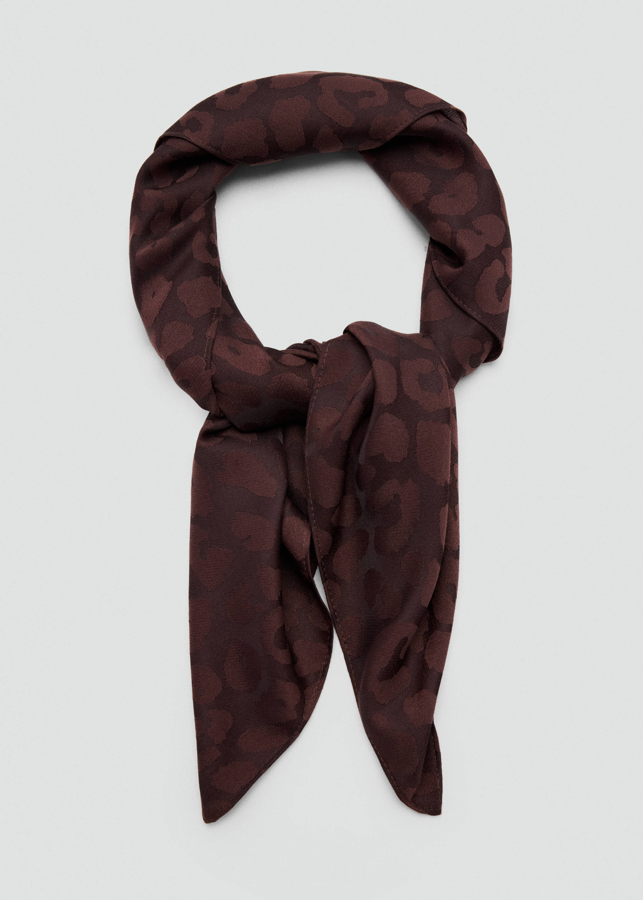Dark brown leopard print scarf in a tied loop.