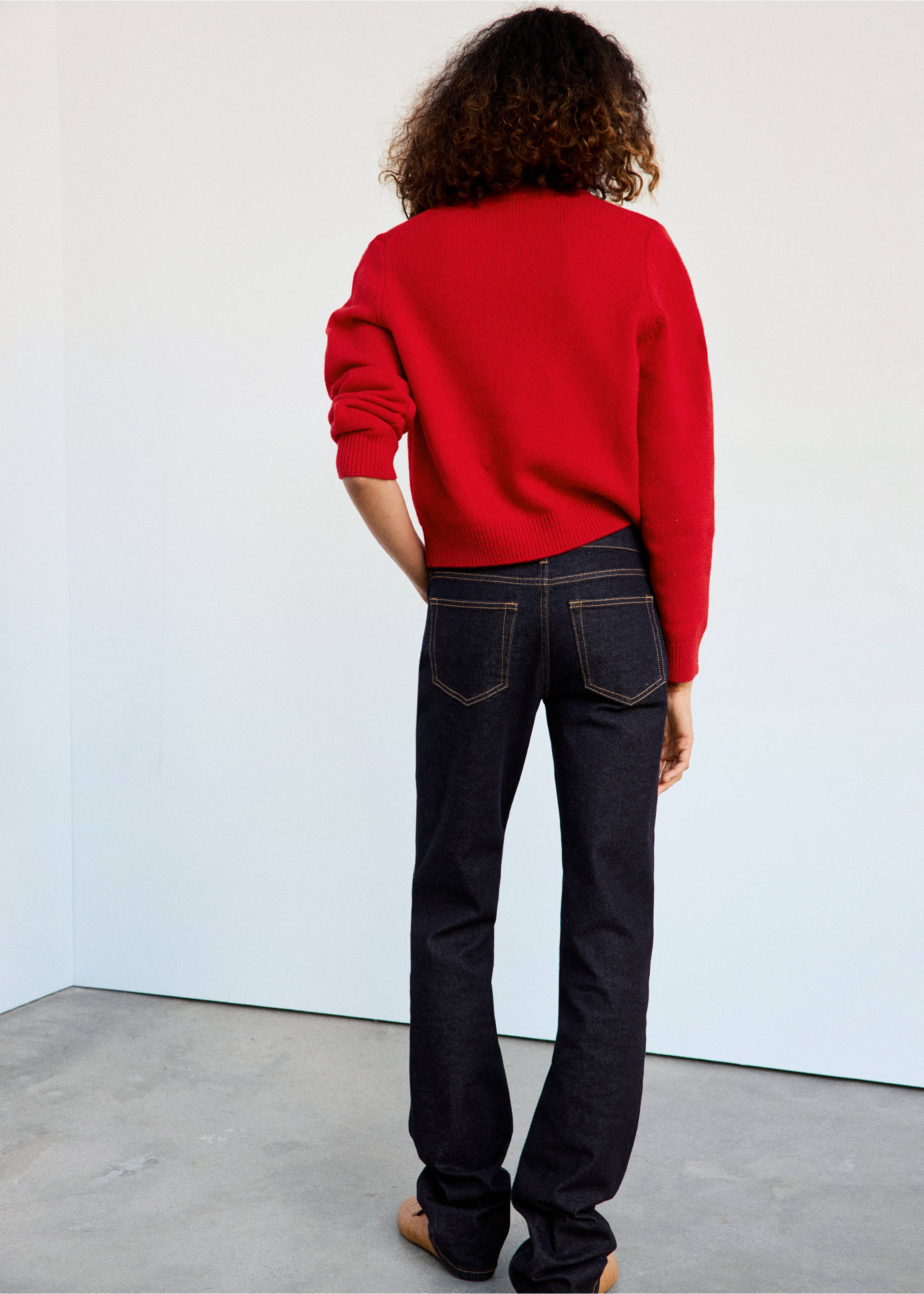 Red knit jersey from the back, worn with dark denim trousers., Red. Ref: 47041362-00.