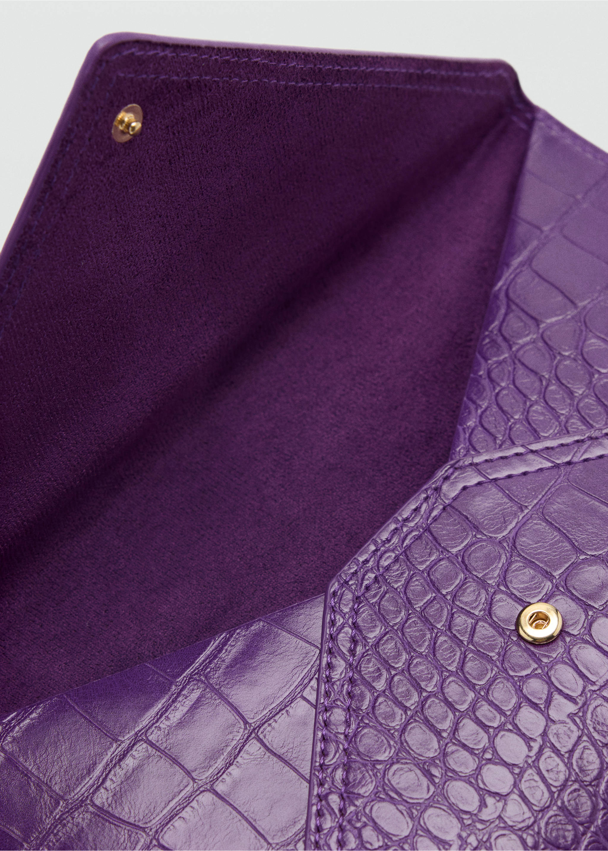 Close-up of a purple crocodile-embossed pouch interior and snap closure., Purple. Ref: 47041395-00.