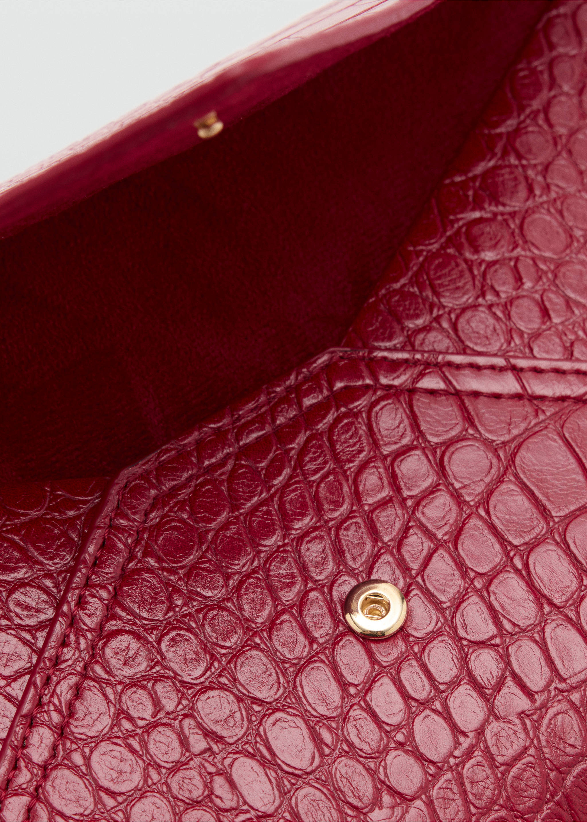 Red pouch accessory detail showing the interior and a gold-toned snap button., Red. Ref: 47041395-00.