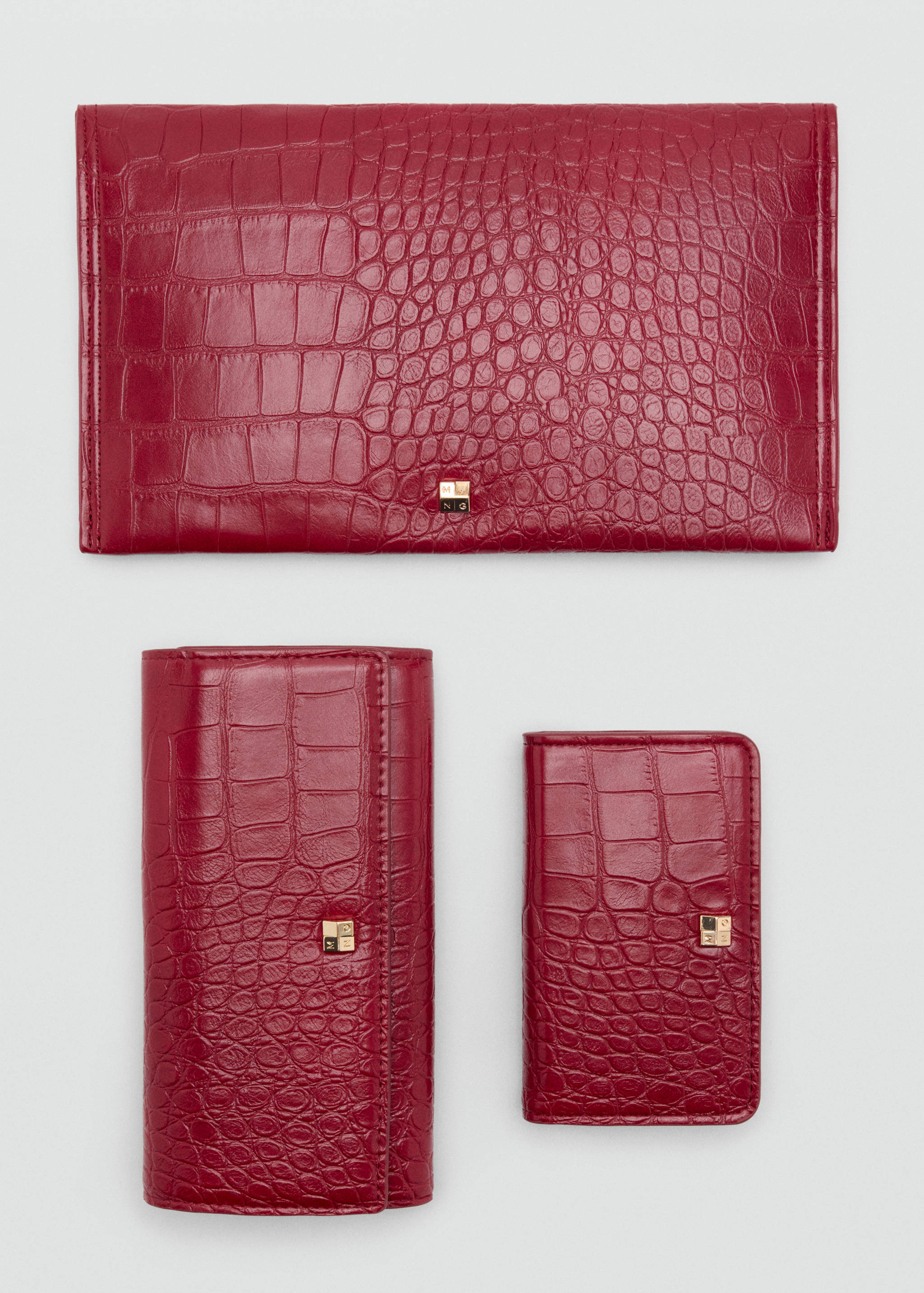 Dark red crocodile-embossed pouch, wallet and cardholder set with gold-tone hardware.