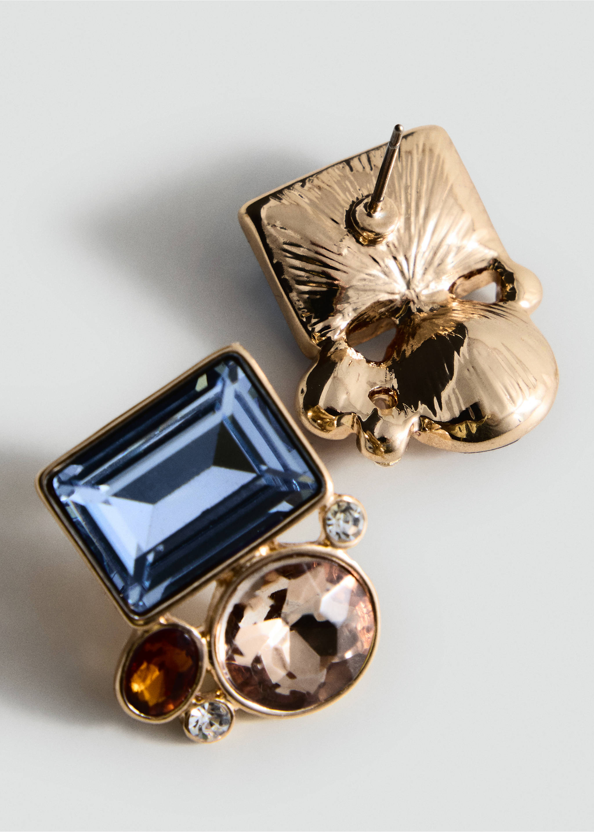 Close-up of gold-toned earrings featuring multi-coloured faceted stones., Gold. Ref: 47041461-00.
