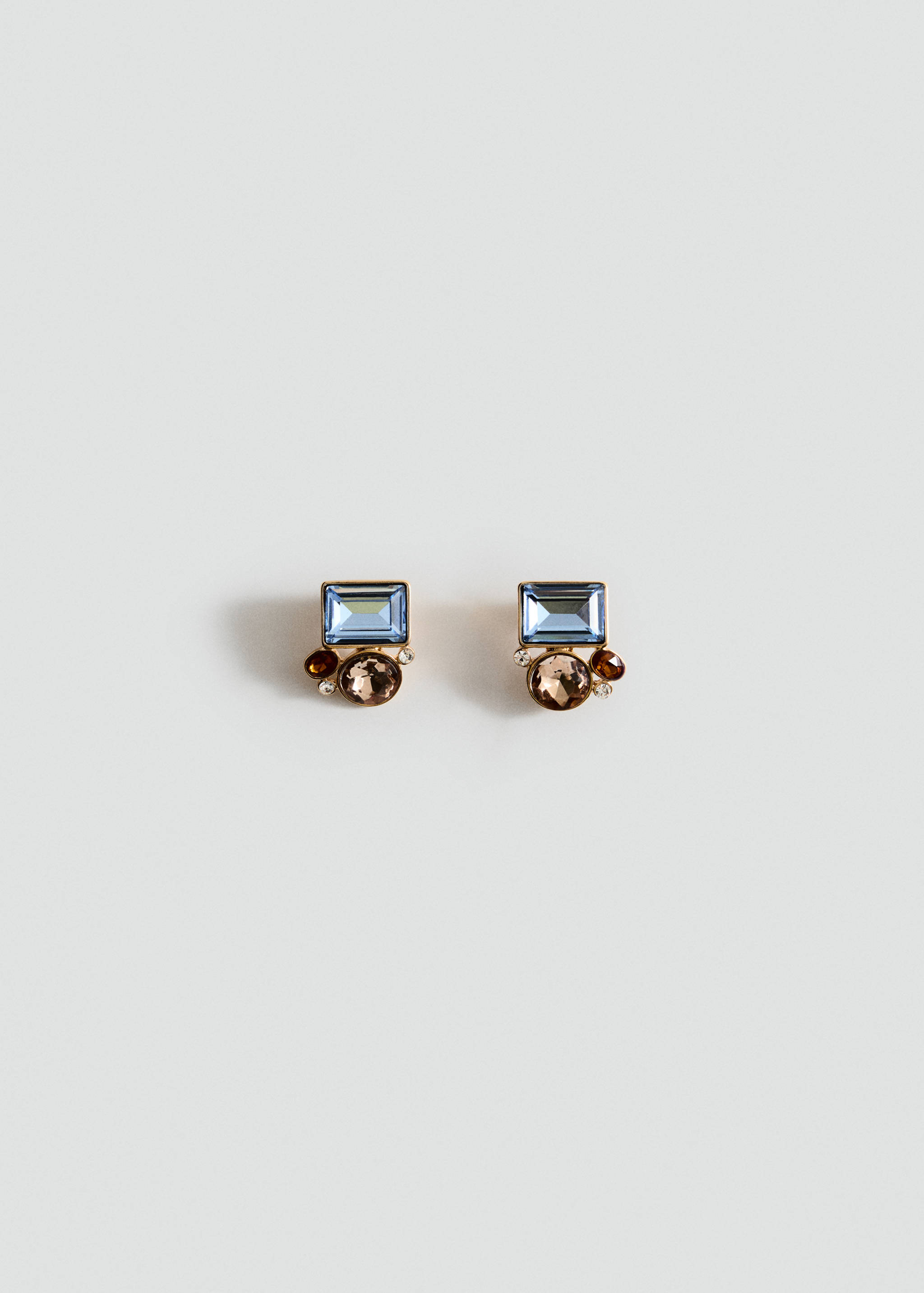 Gold-toned stud earrings with a pale blue rectangular stone and brown crystal cluster.