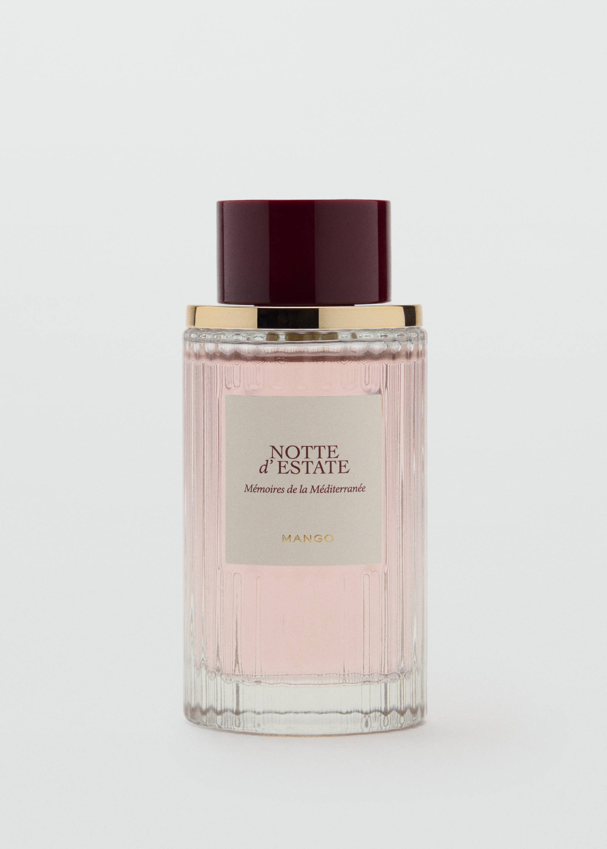 Glass perfume bottle with pale pink liquid, burgundy cap, and Notte d'Estate label.