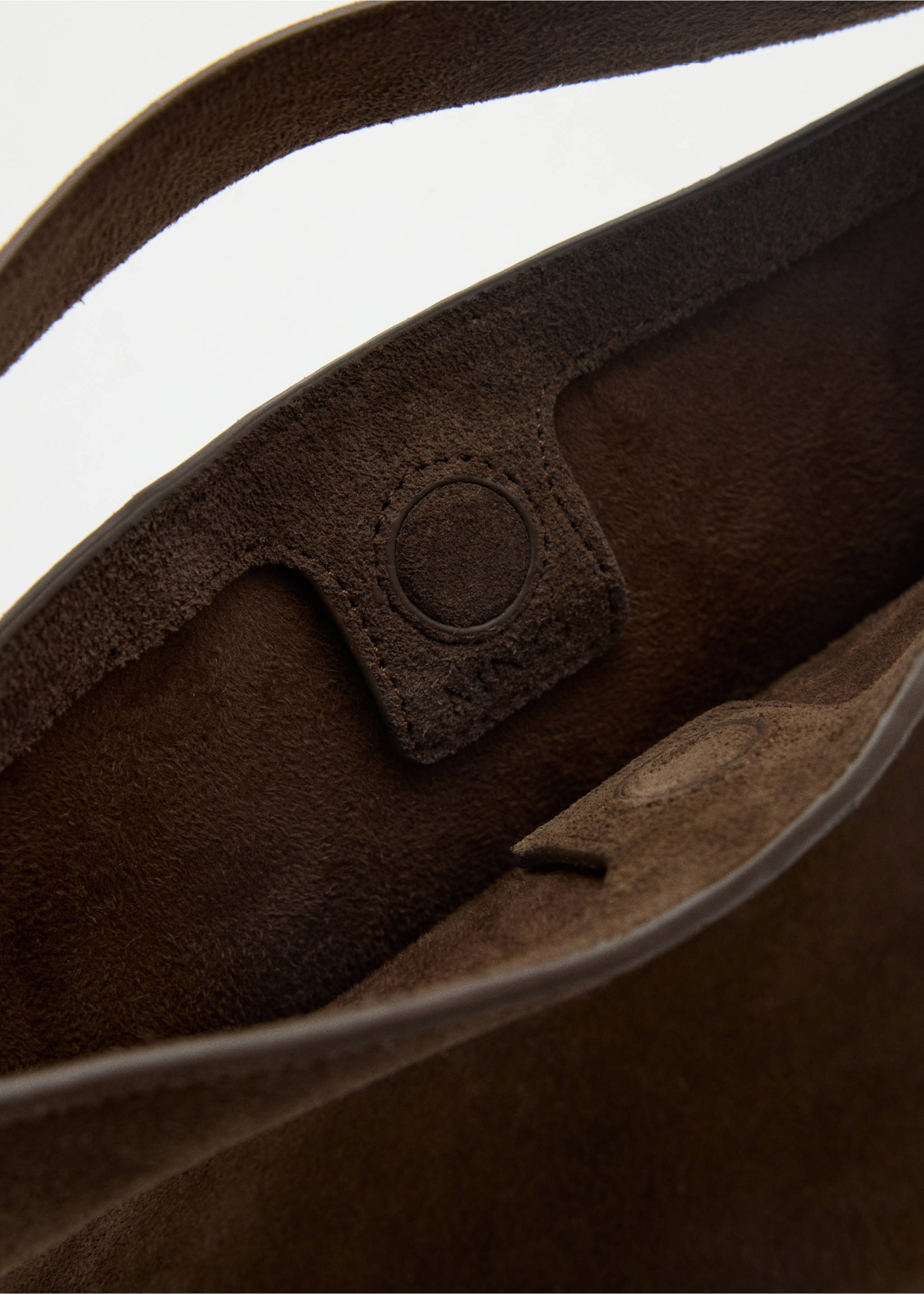 Close-up of the interior and magnetic closure of a brown suede bucket bag., Brown. Ref: 47051343-00.