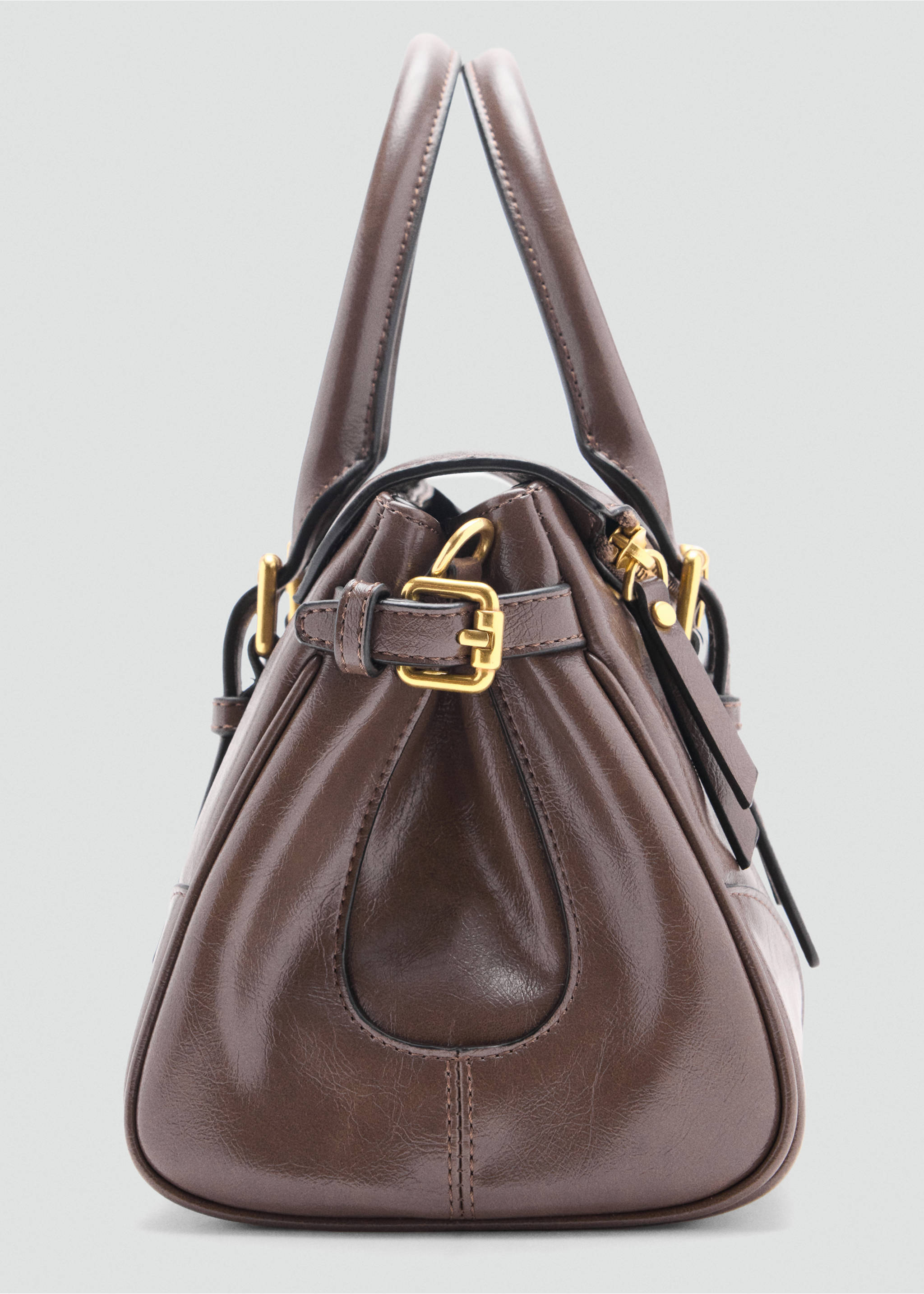 Close-up of the side of a brown City bag with gold-tone hardware., Medium Brown. Ref: 47051345-00.