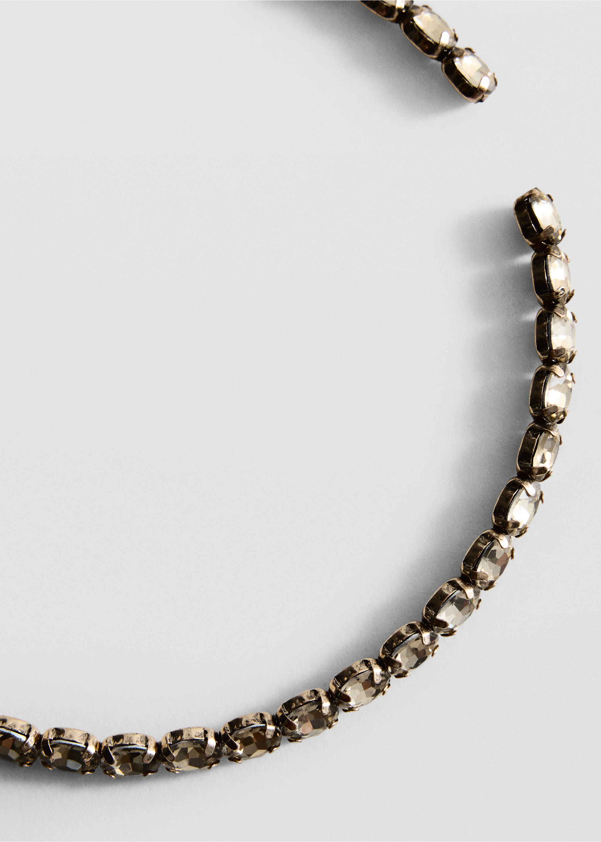 Close-up of a rhinestone collar necklace with faceted crystals., Gold. Ref: 47051386-00.