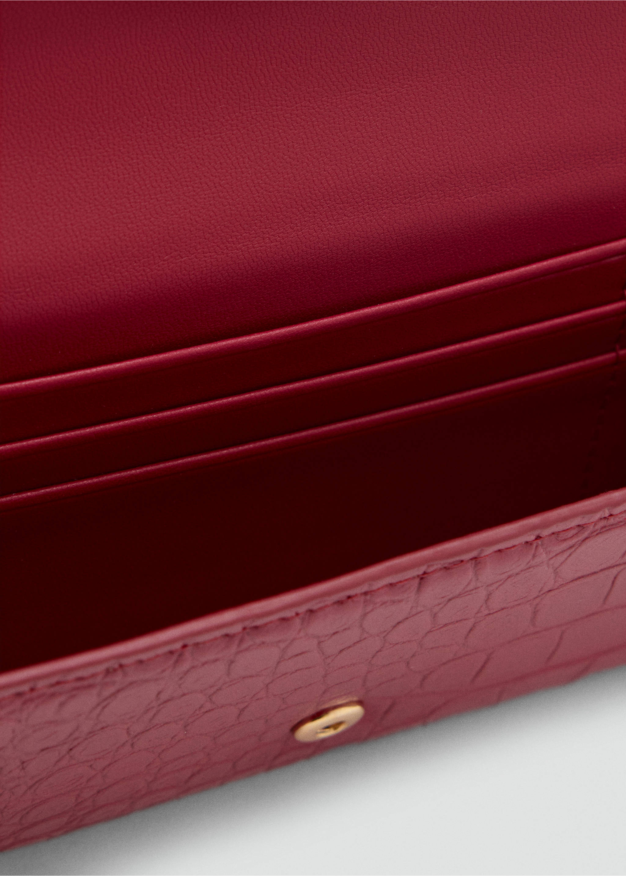 Close-up of a dark red wallet with a crocodile-embossed texture and snap closure., Red. Ref: 47051395-00.