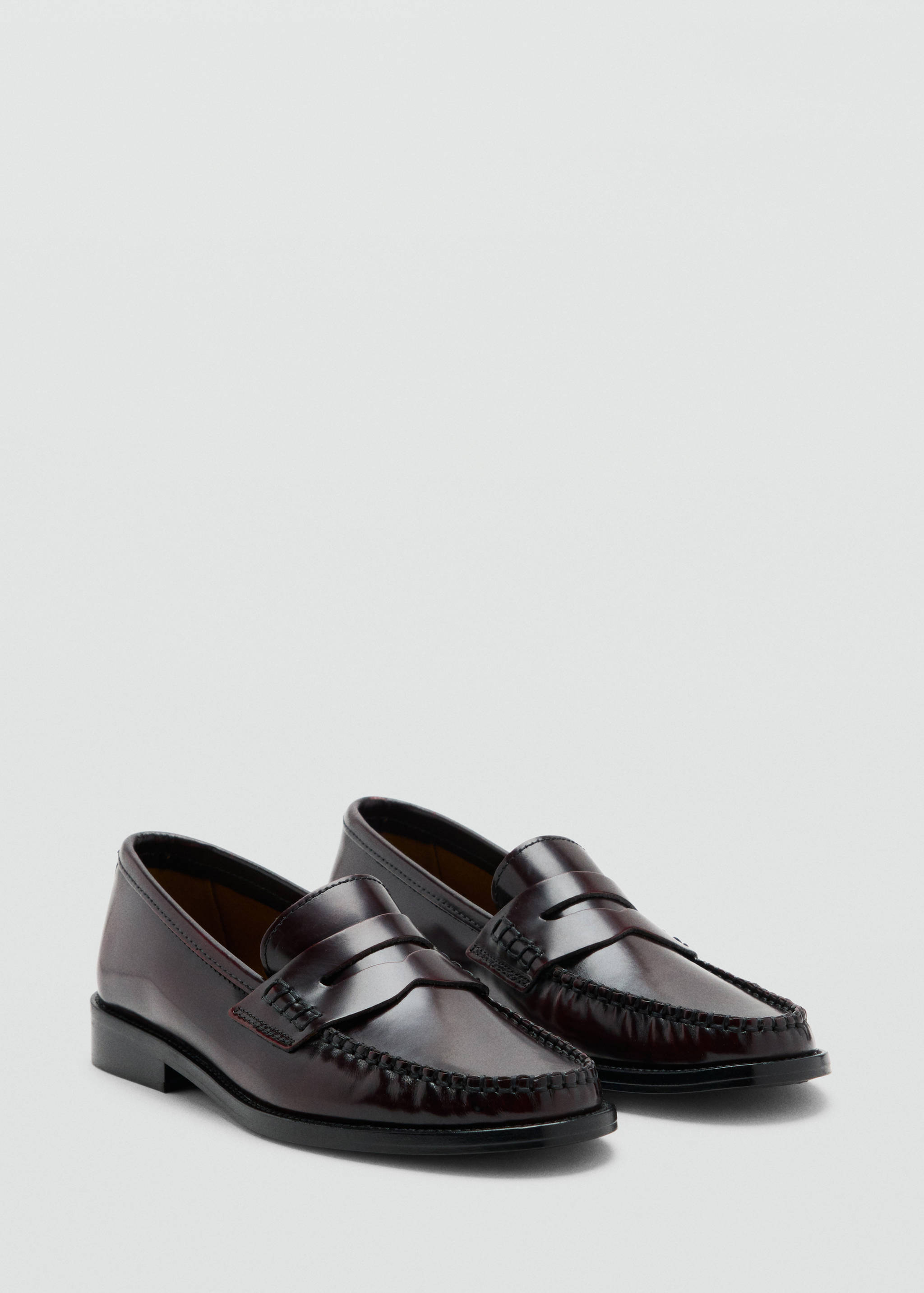 Burgundy leather penny loafers with glossy finish and moc toe.