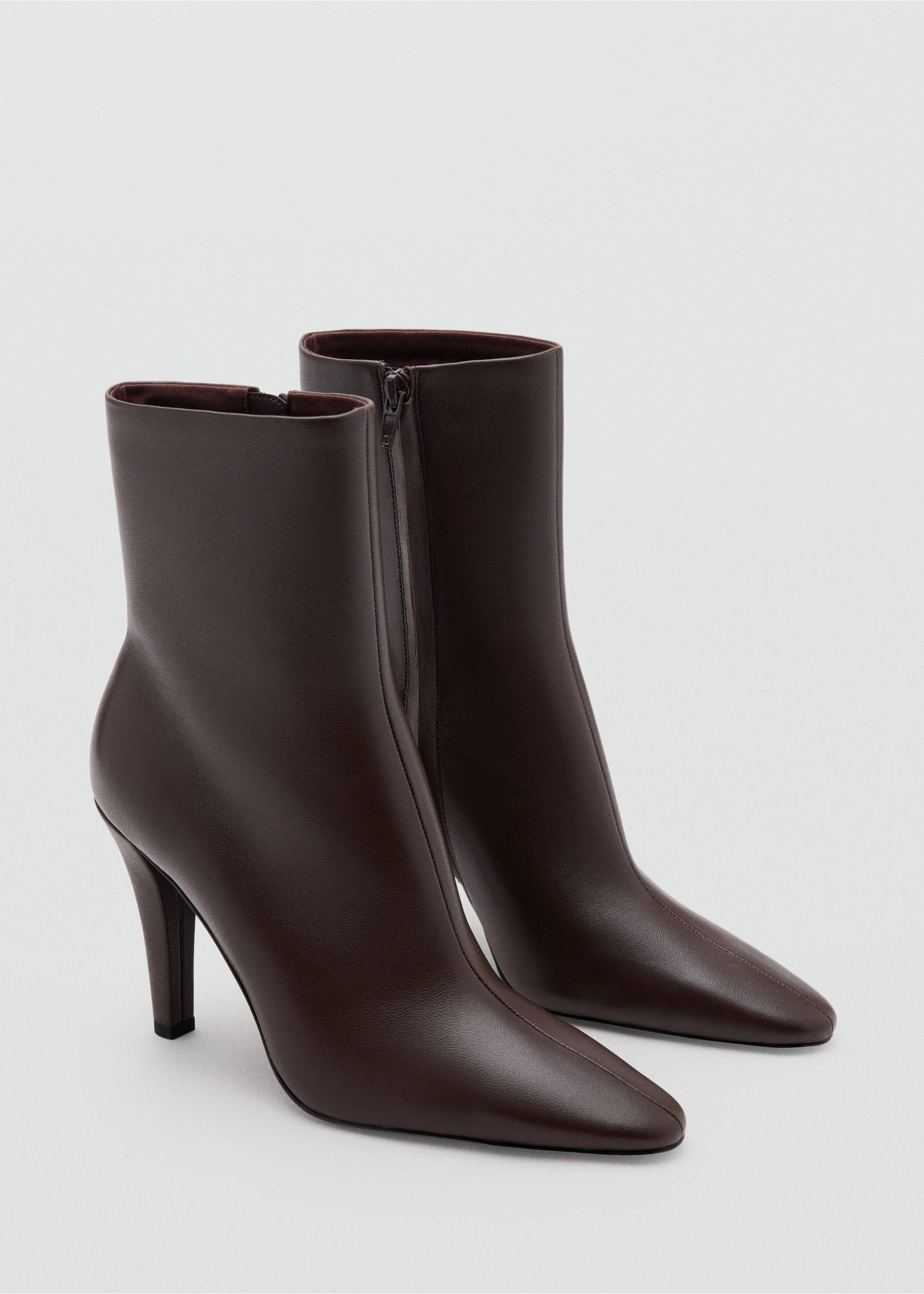 Dark brown heeled ankle boots with pointed toes and slim heels in a three-quarter view., Chocolate. Ref: 47061332-00.