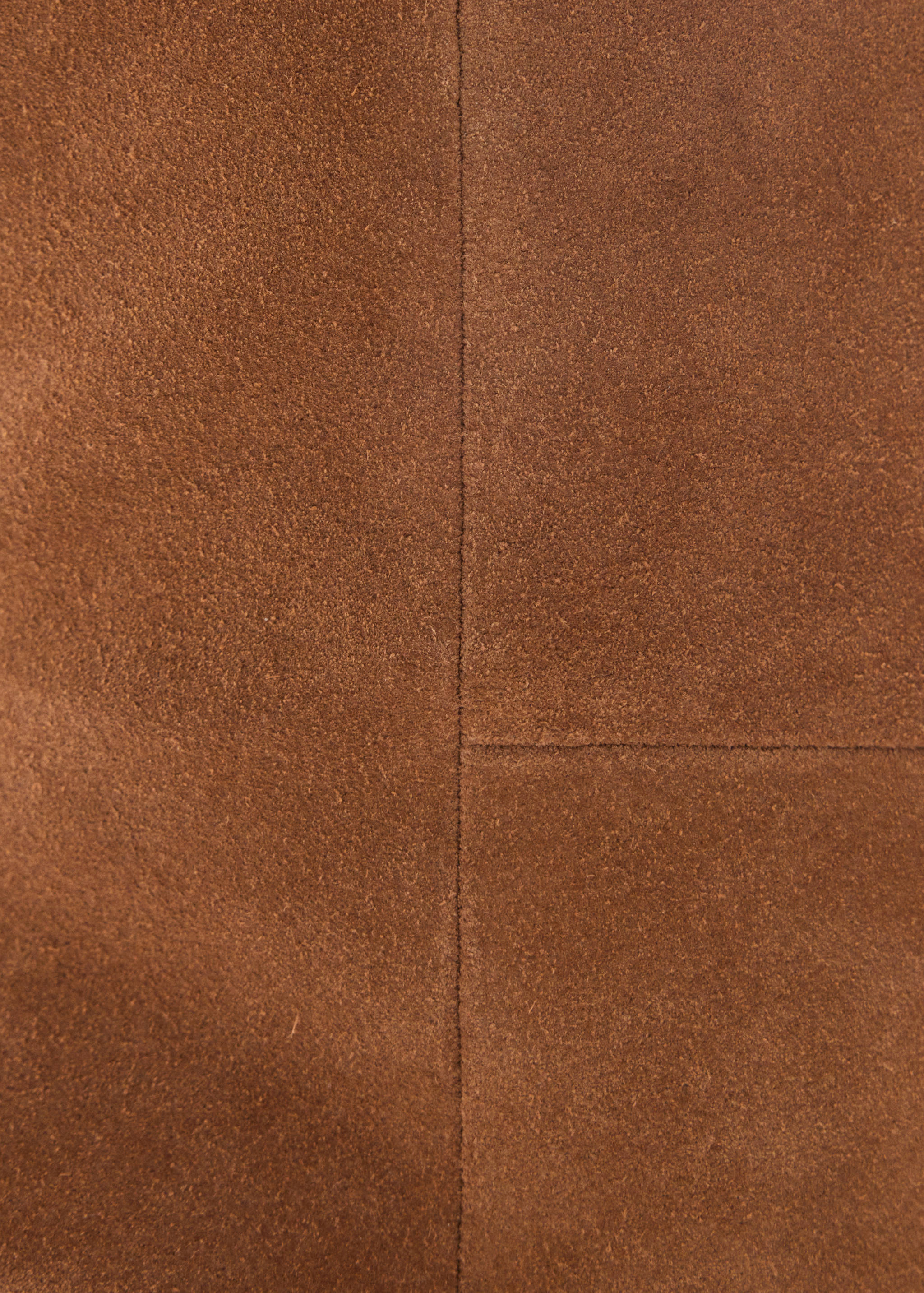 Brown suede boot detail showing panel stitching.