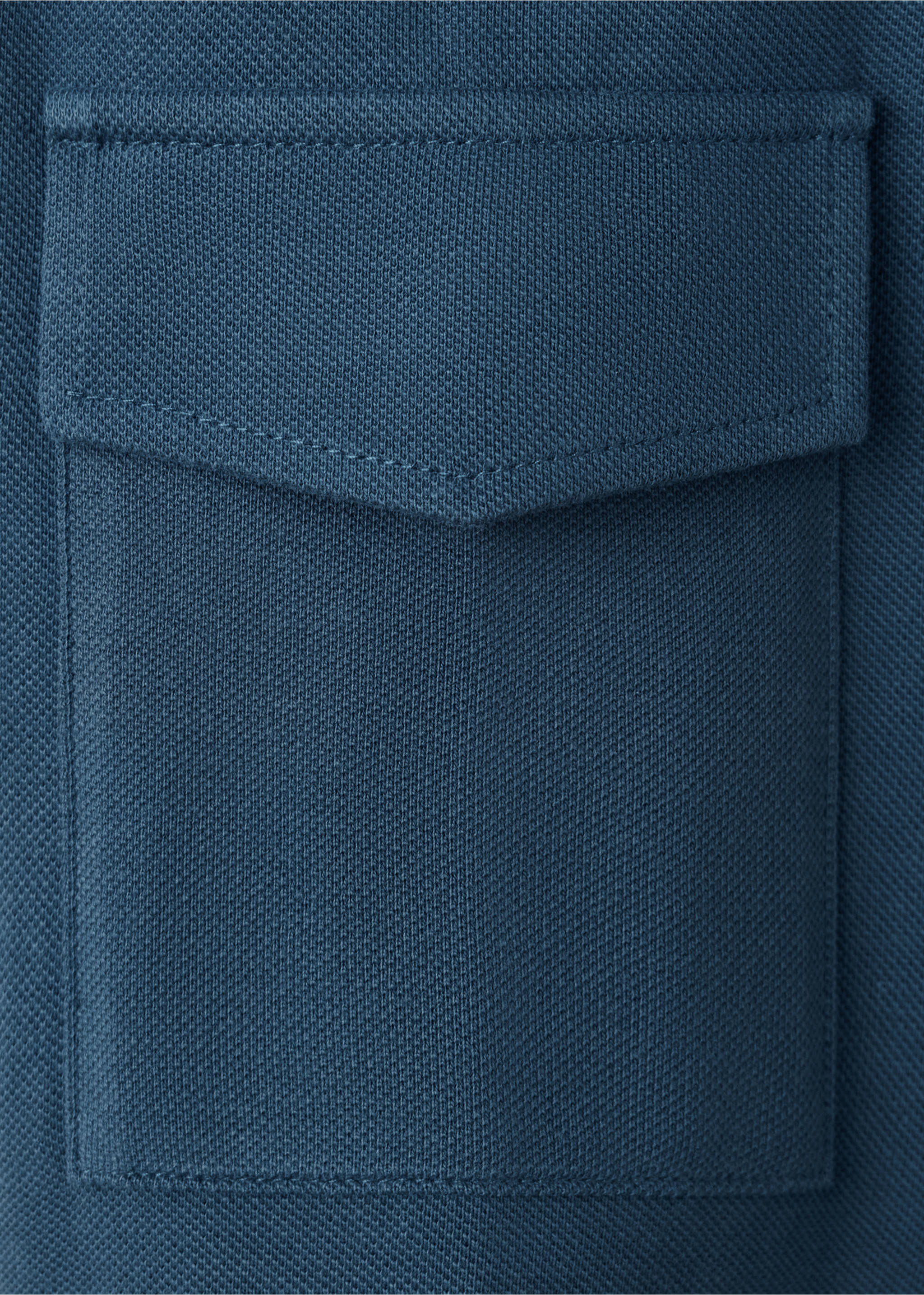 Close-up of blue polo shirt fabric showing textured knit and chest pocket., Navy. Ref: 47061339-00.