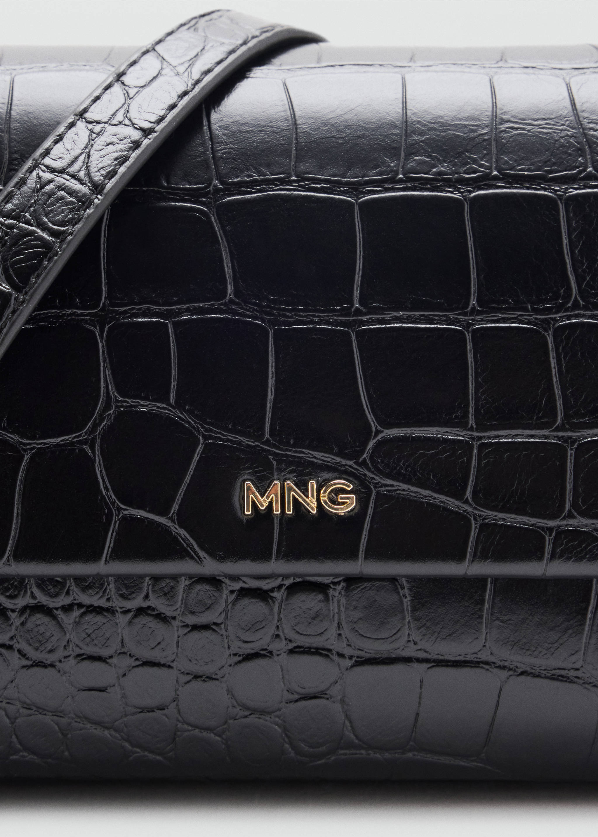 Black crocodile-effect crossbody bag detail with gold MNG lettering., Black. Ref: 47061341-00.