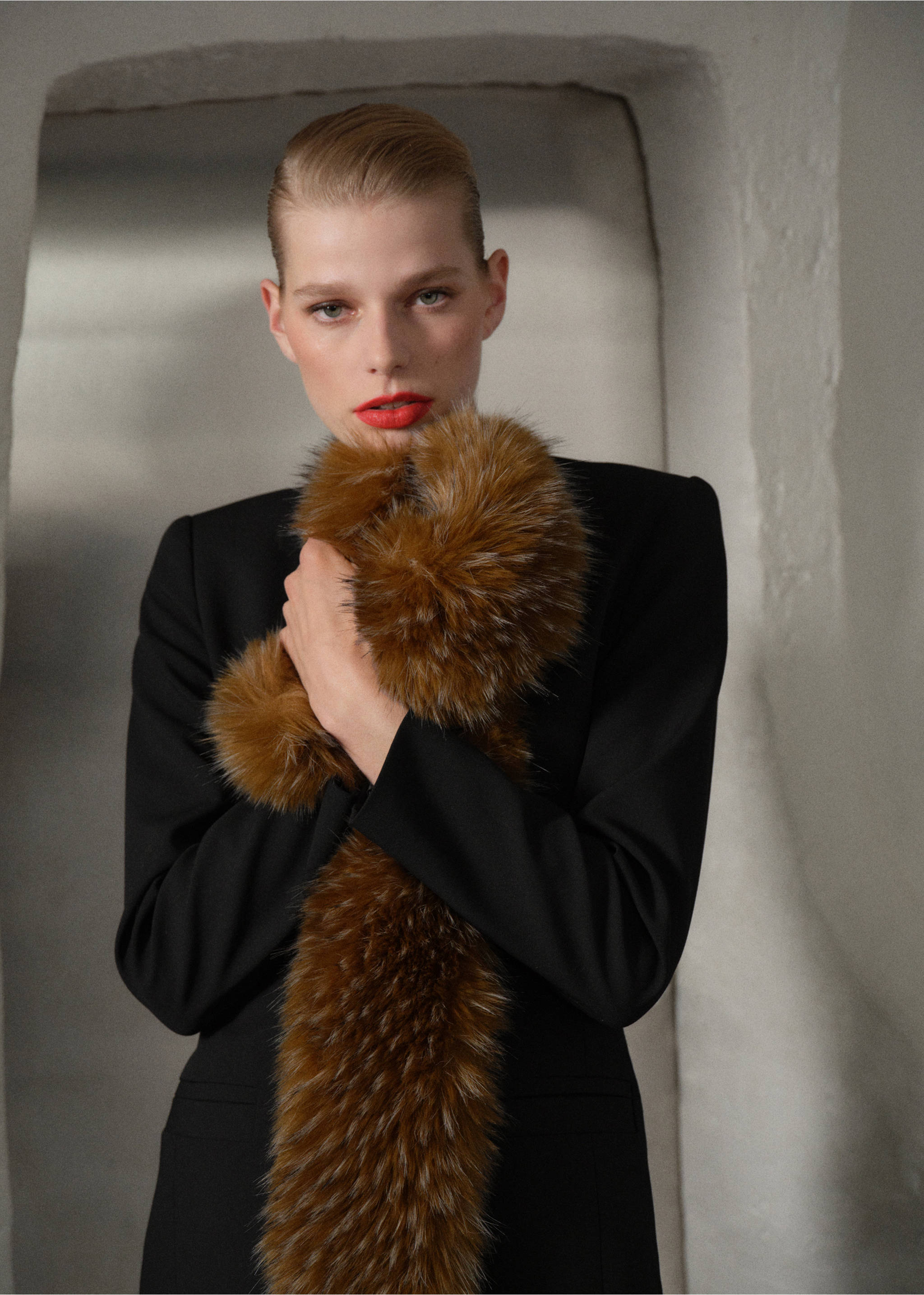 Brown faux-fur scarf worn with a black blazer., Chocolate. Ref: 47061375-00.