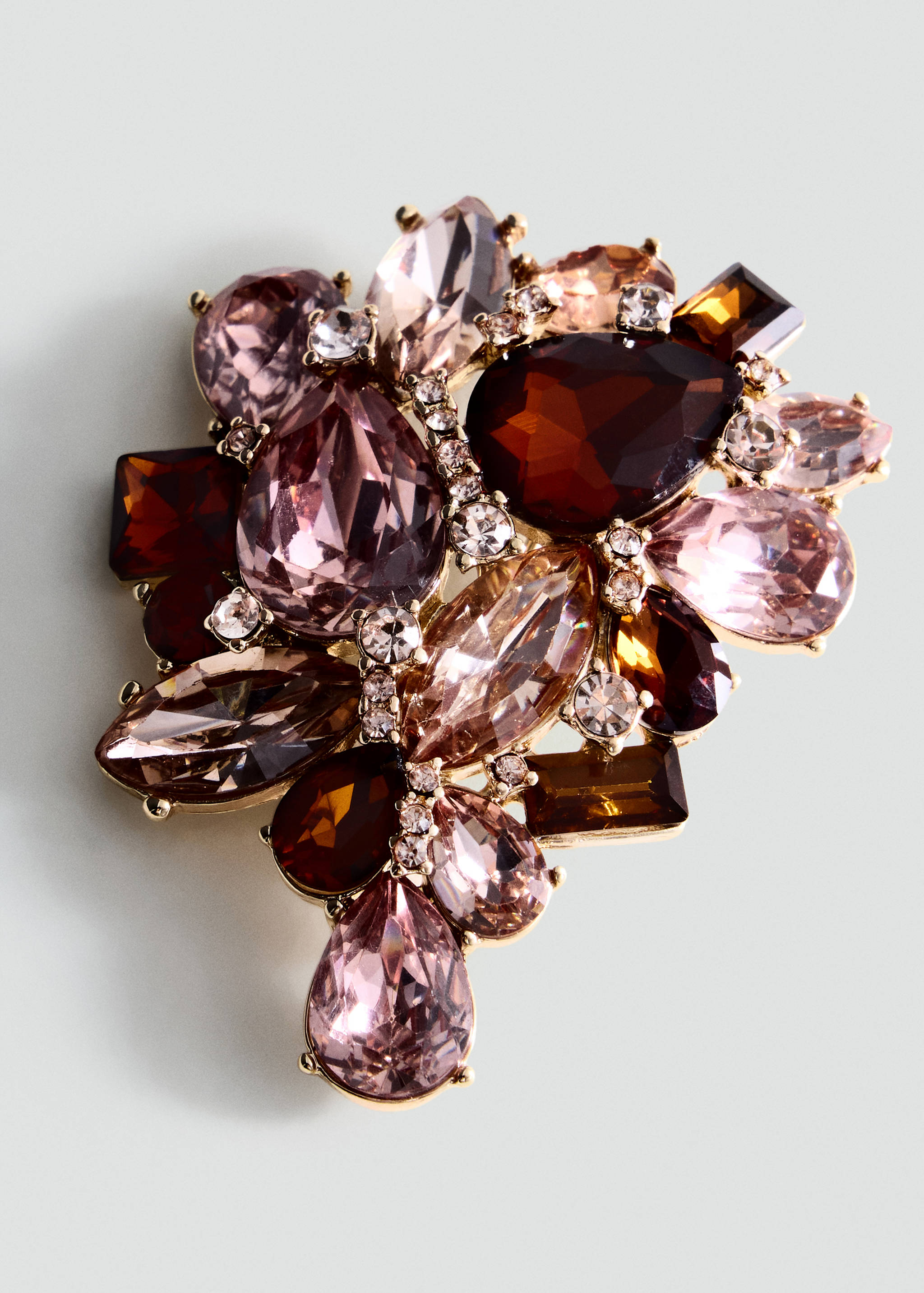 Decorative gold-tone brooch with clustered brown and pink crystal stones.