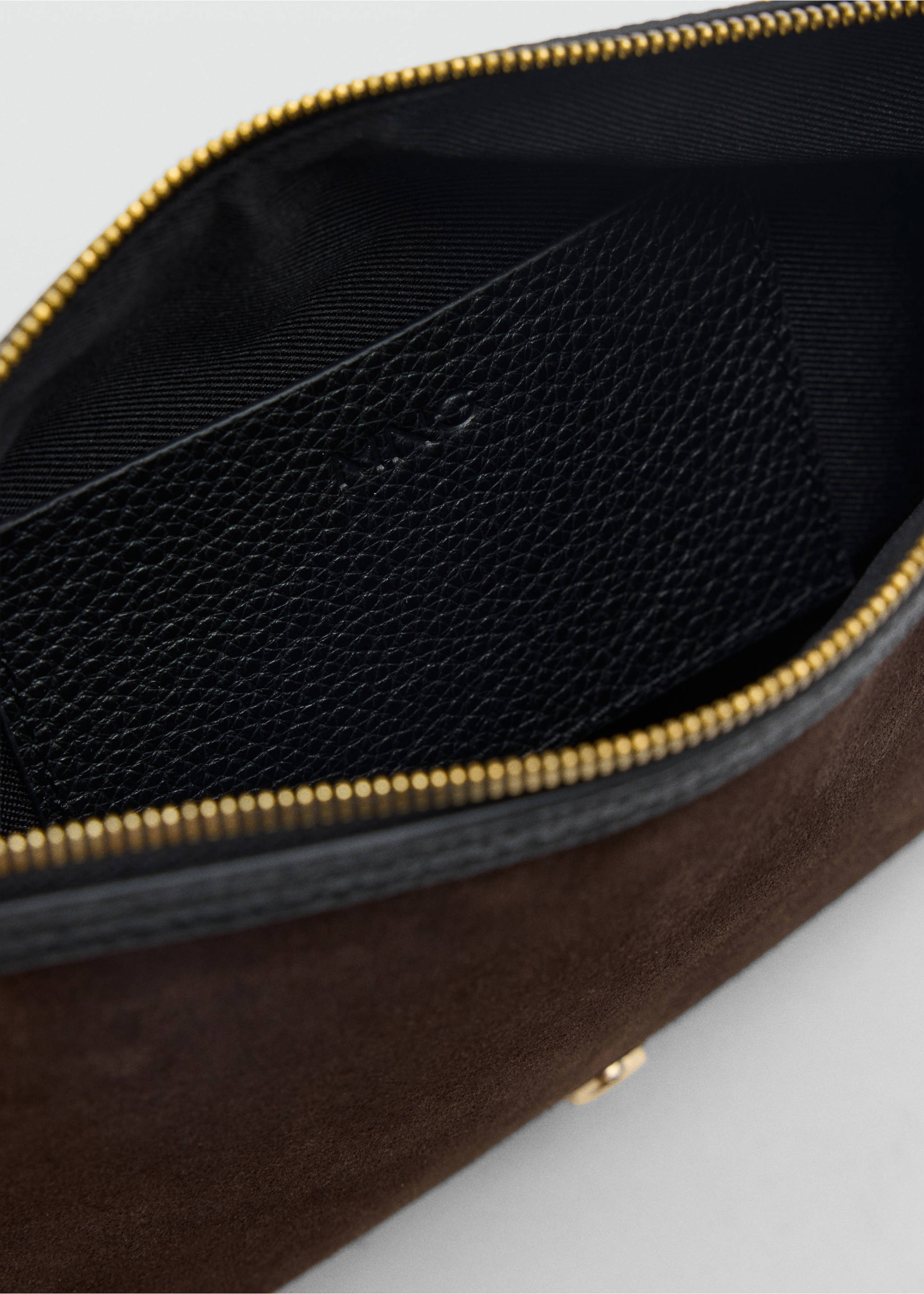 Close-up of the interior of a dark brown suede wash bag with a black pocket., Chocolate. Ref: 47061391-00.