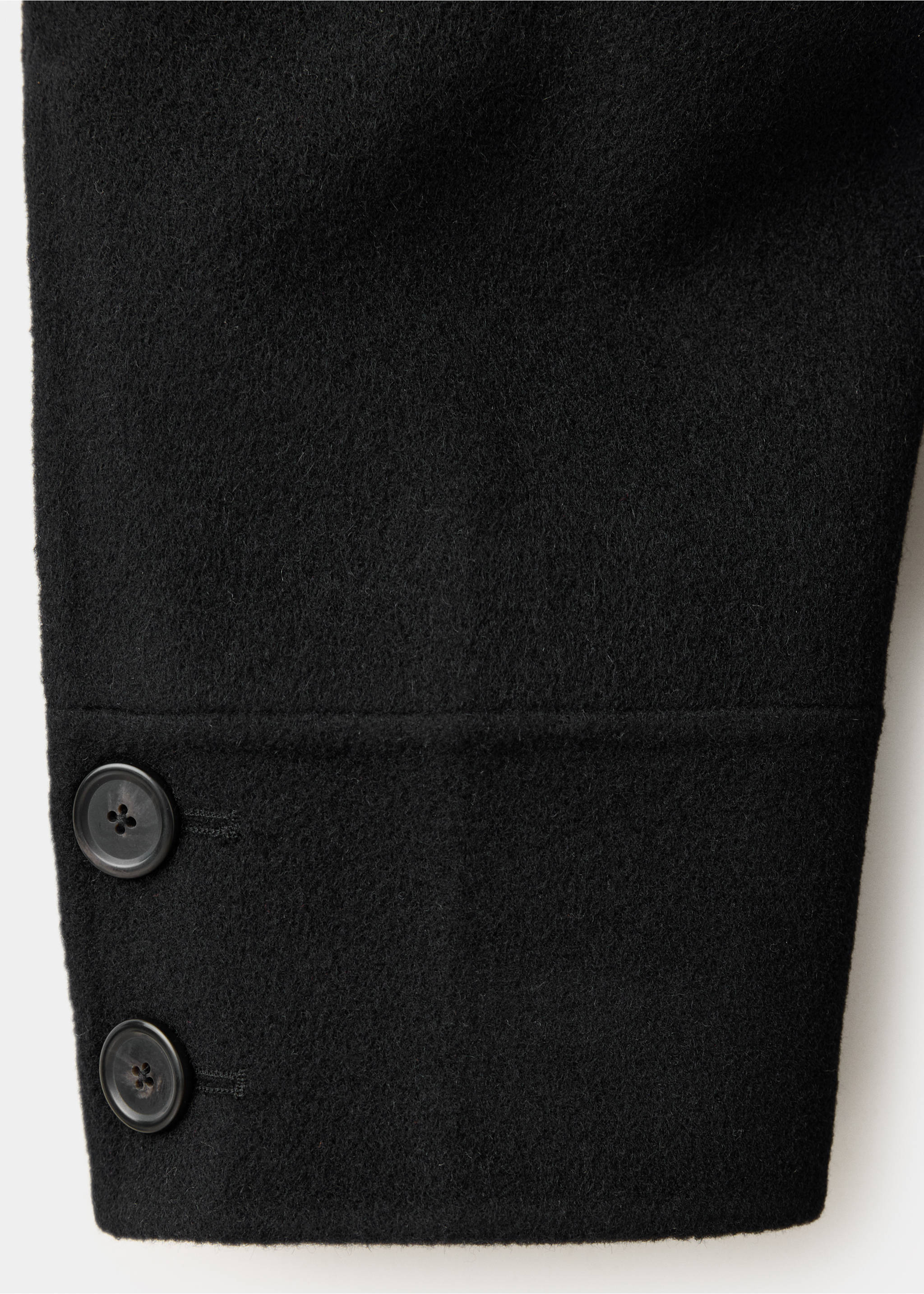Black coat fabric detail showing the sleeve cuff and two buttons., Black. Ref: 47061446-00.