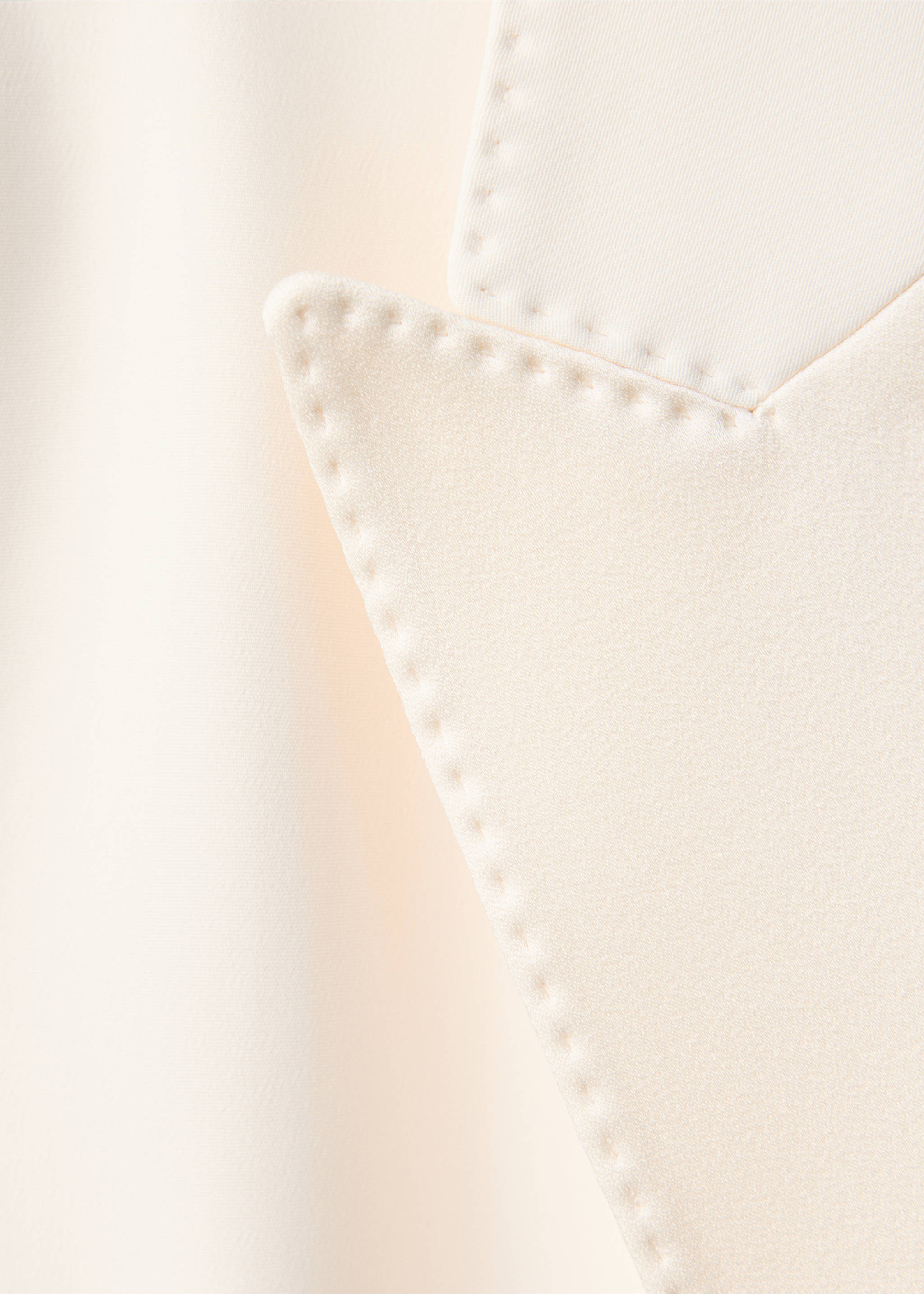 Close-up of the cream blazer lapel showing fabric texture and topstitching details., Ecru. Ref: 47061470-00.