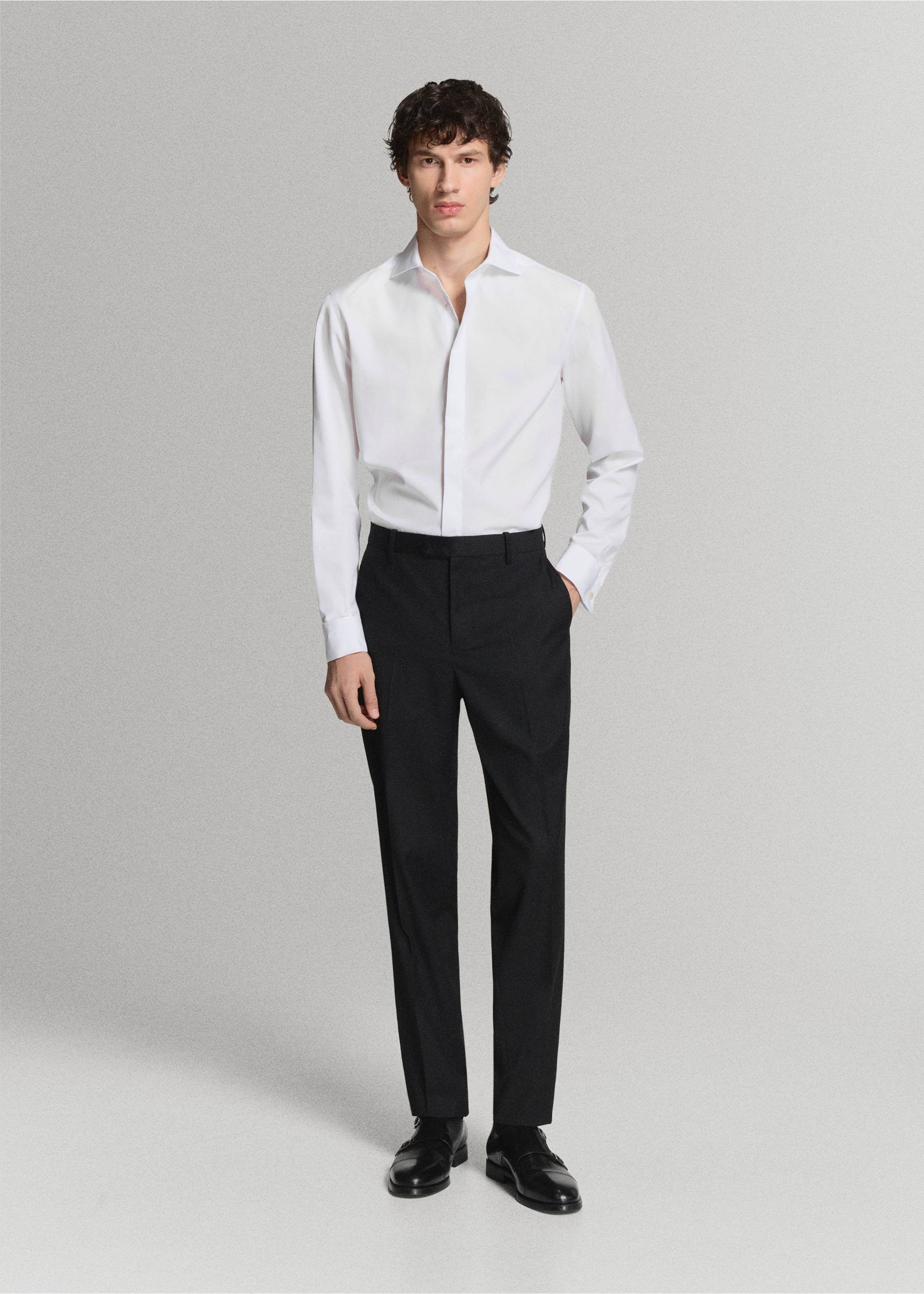White long-sleeved shirt with point collar, worn with dark trousers., White. Ref: 47071334-00.
