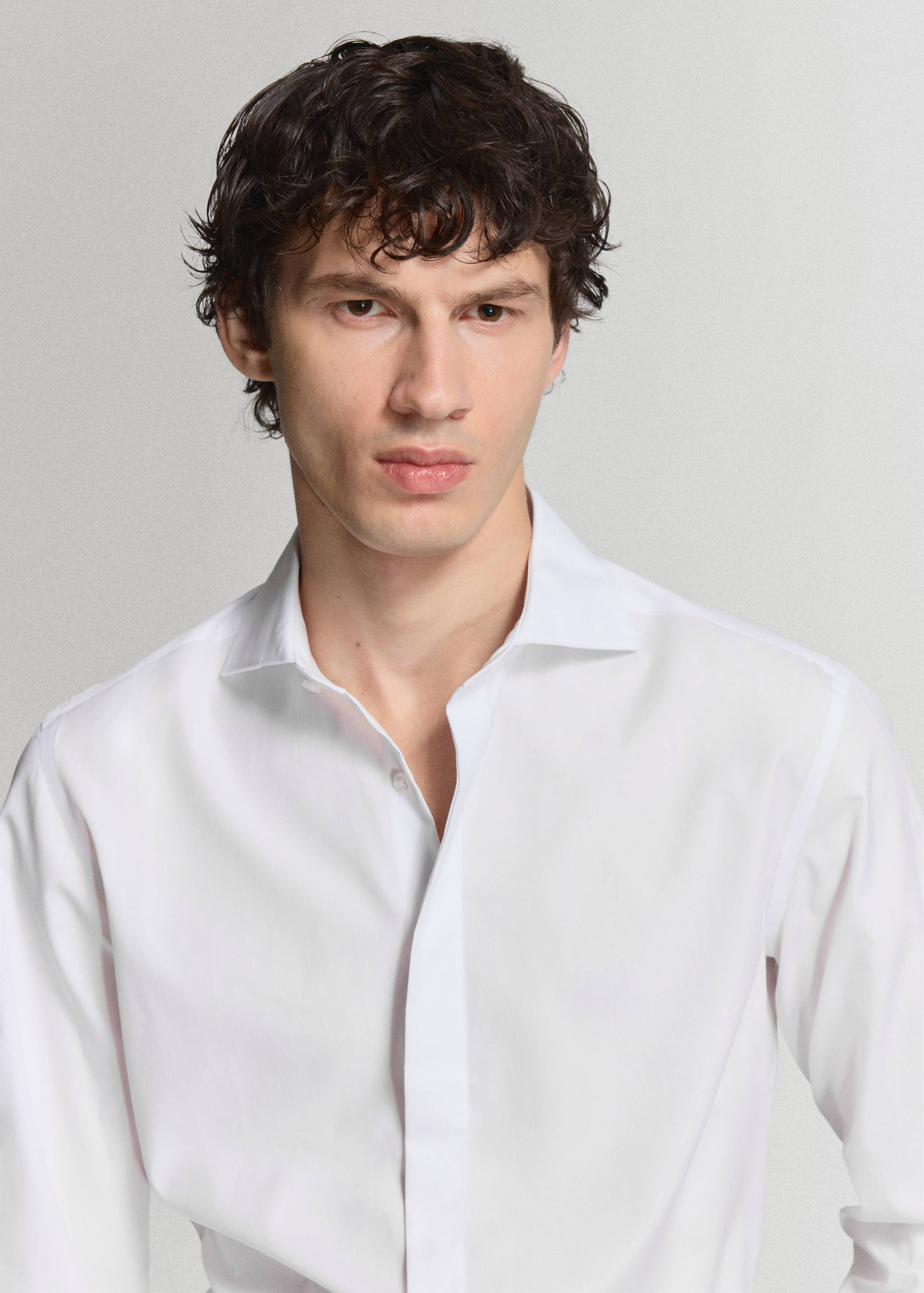 Close-up of a white shirt with a classic collar.