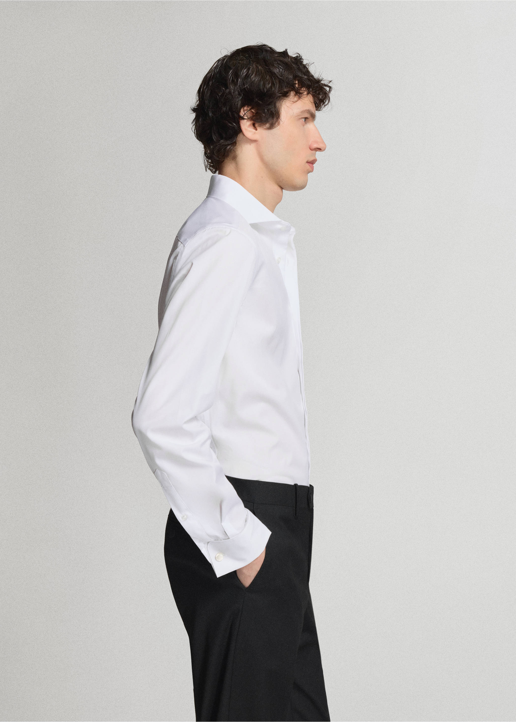 White long-sleeved shirt with a classic collar and buttoned cuffs, shown in a side profile view., White. Ref: 47071334-00.
