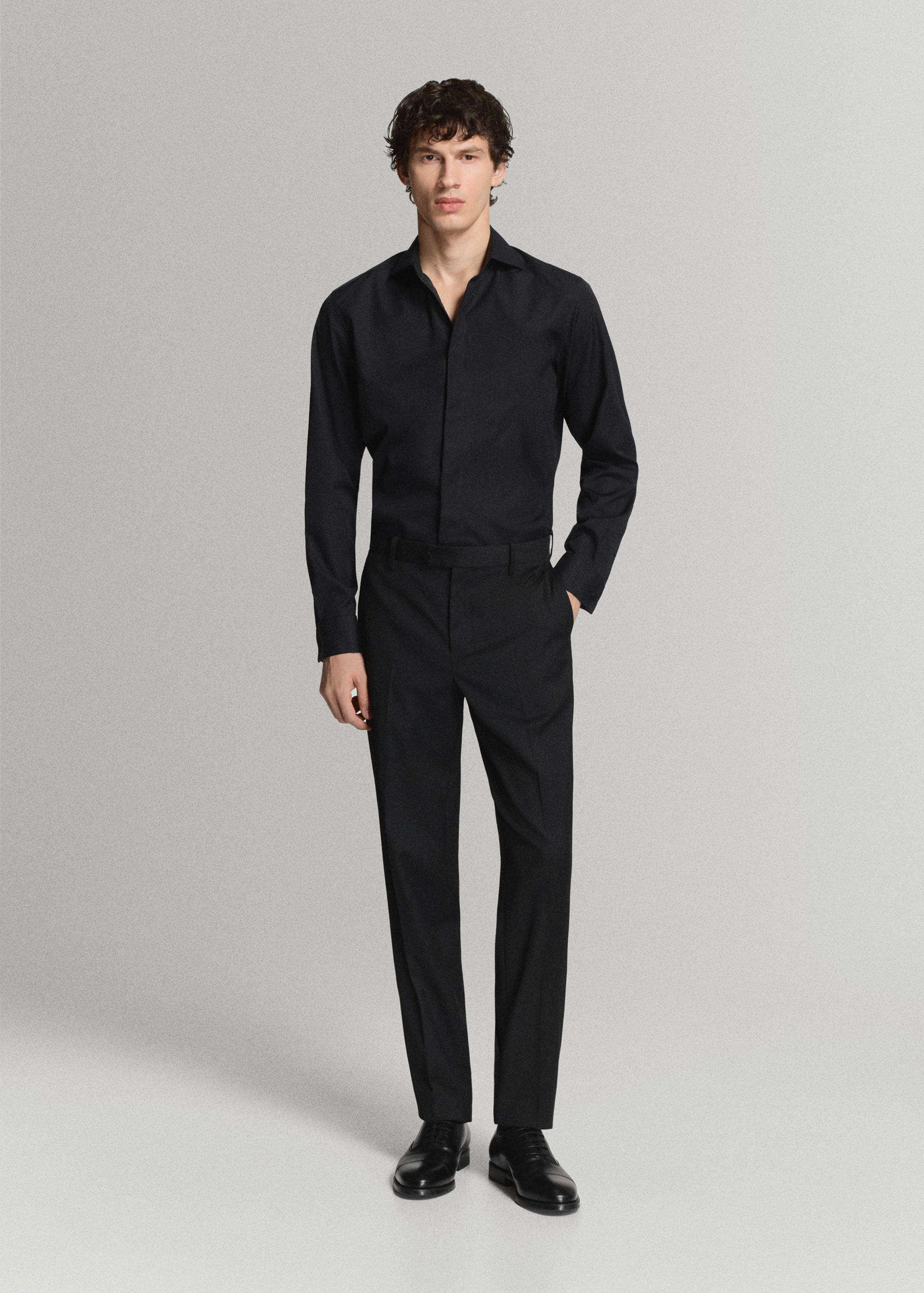 Black long-sleeved shirt with a classic collar and covered button placket.
