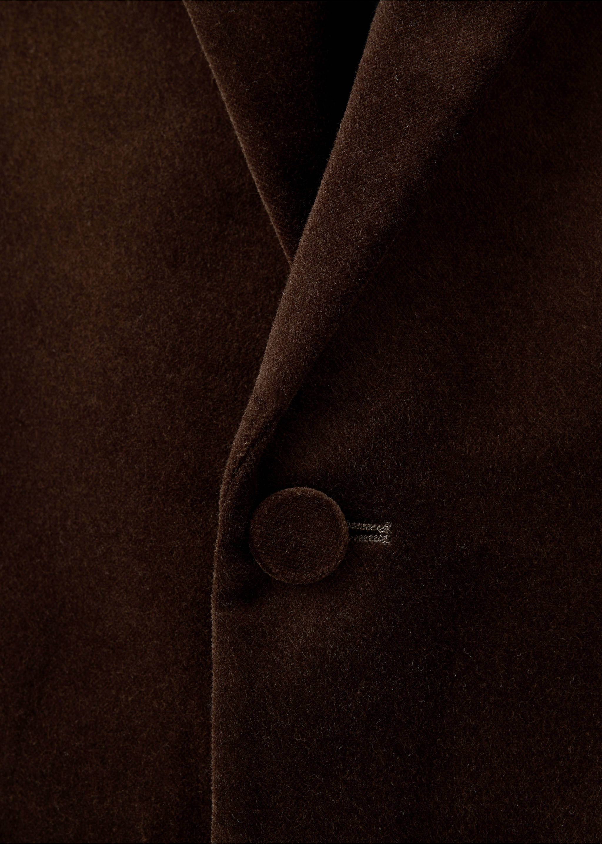 Close-up of a dark brown blazer with a fabric-covered button., Brown. Ref: 47071336-00.