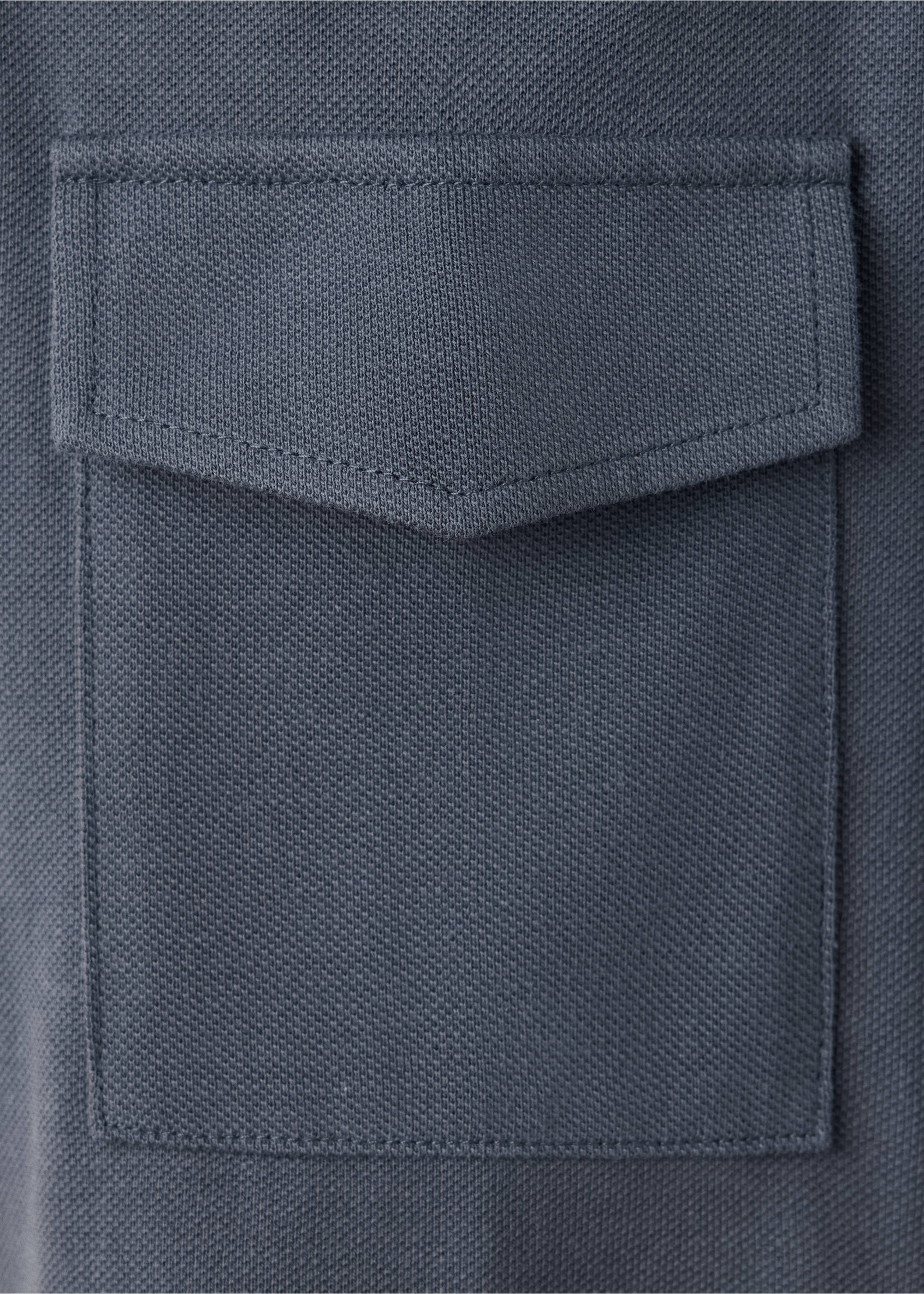 Close-up of the textured fabric and pocket on a dark grey polo., Grey. Ref: 47071338-00.
