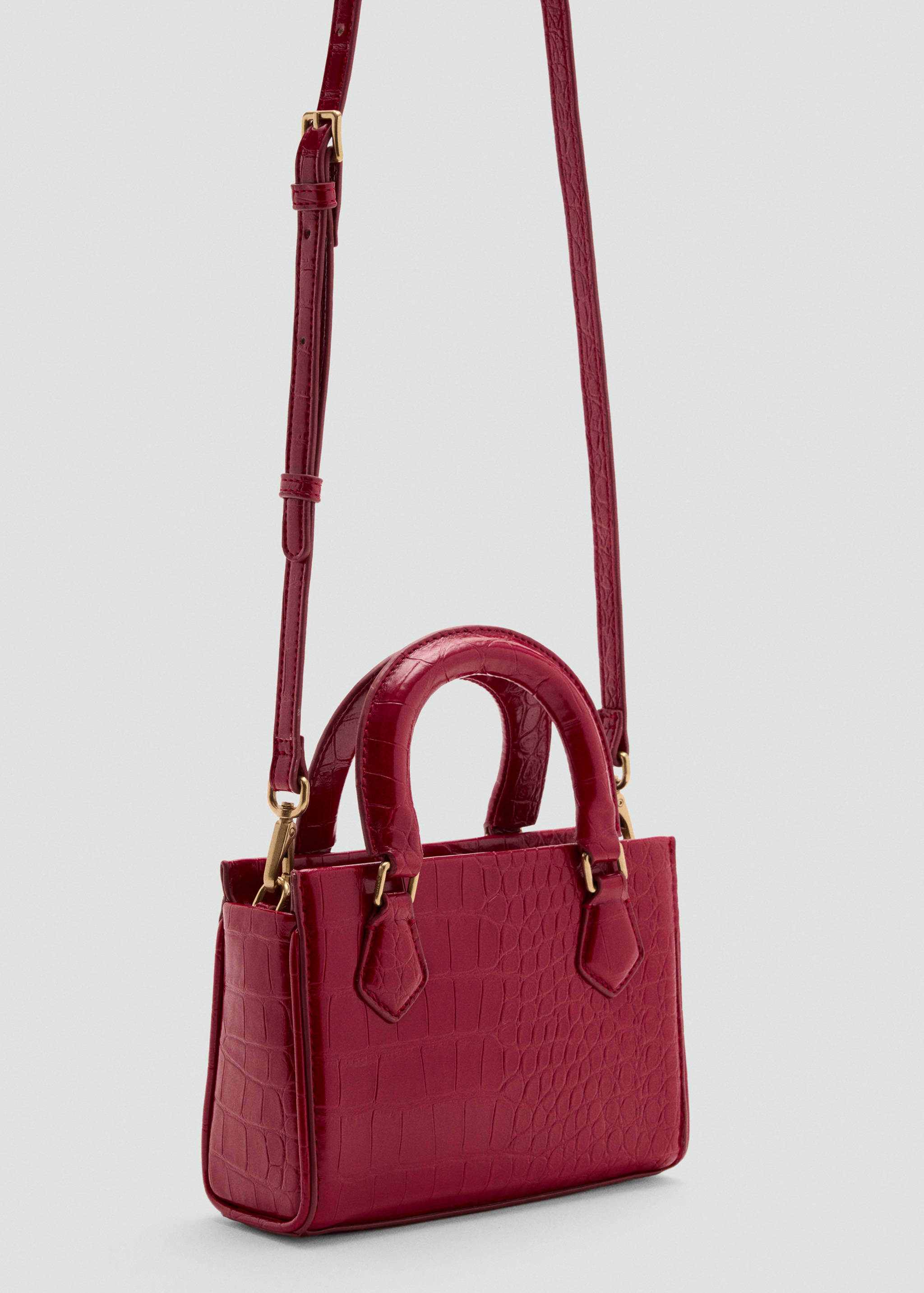 Raspberry red embossed cross-body bag with top handles and gold hardware.