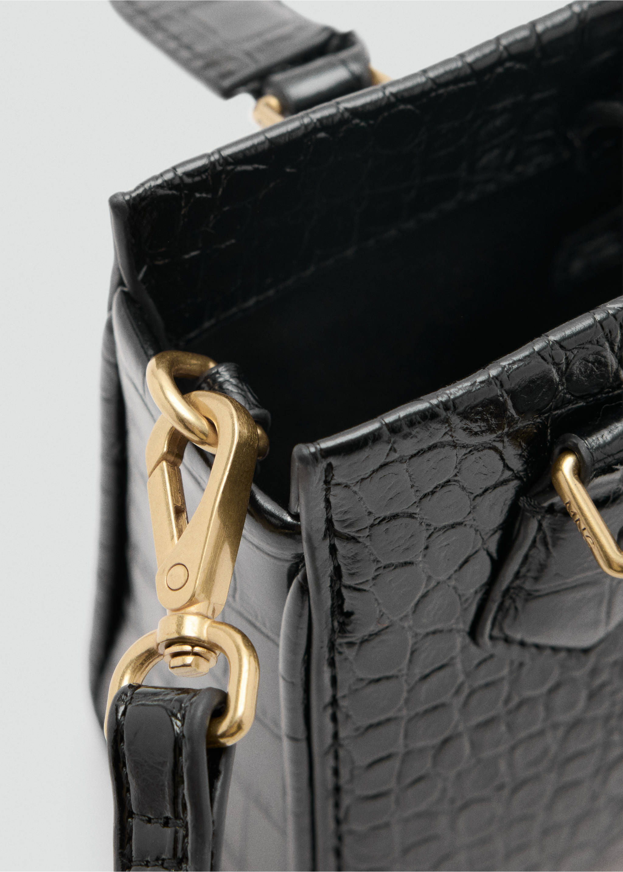 Close-up of a black croc-embossed crossbody bag with gold-tone hardware., Black. Ref: 47071340-00.