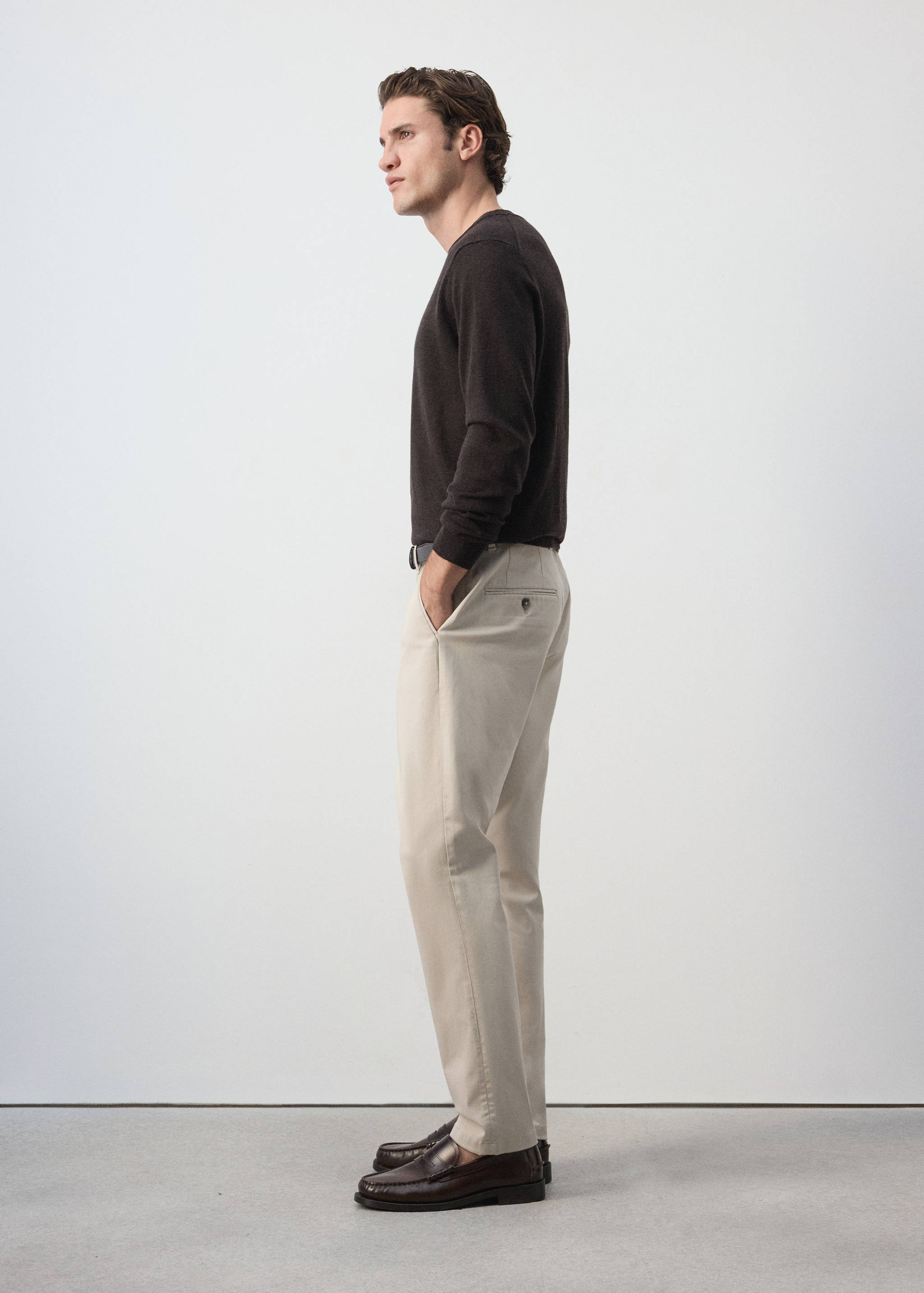 Light beige trousers with a straight fit, styled with a dark brown sweater.