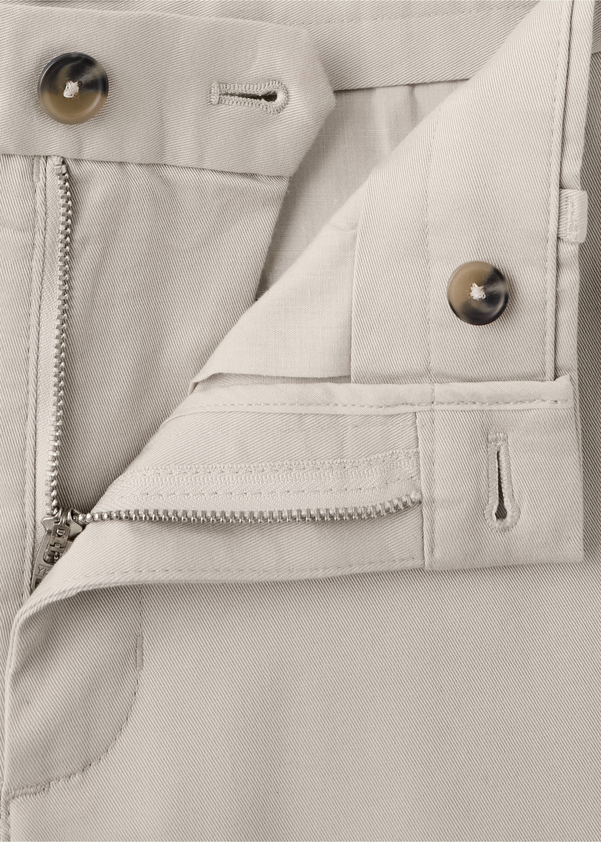 Close-up of beige trousers showing the waistband, zipper, and button details., Ecru. Ref: 47071351-00.