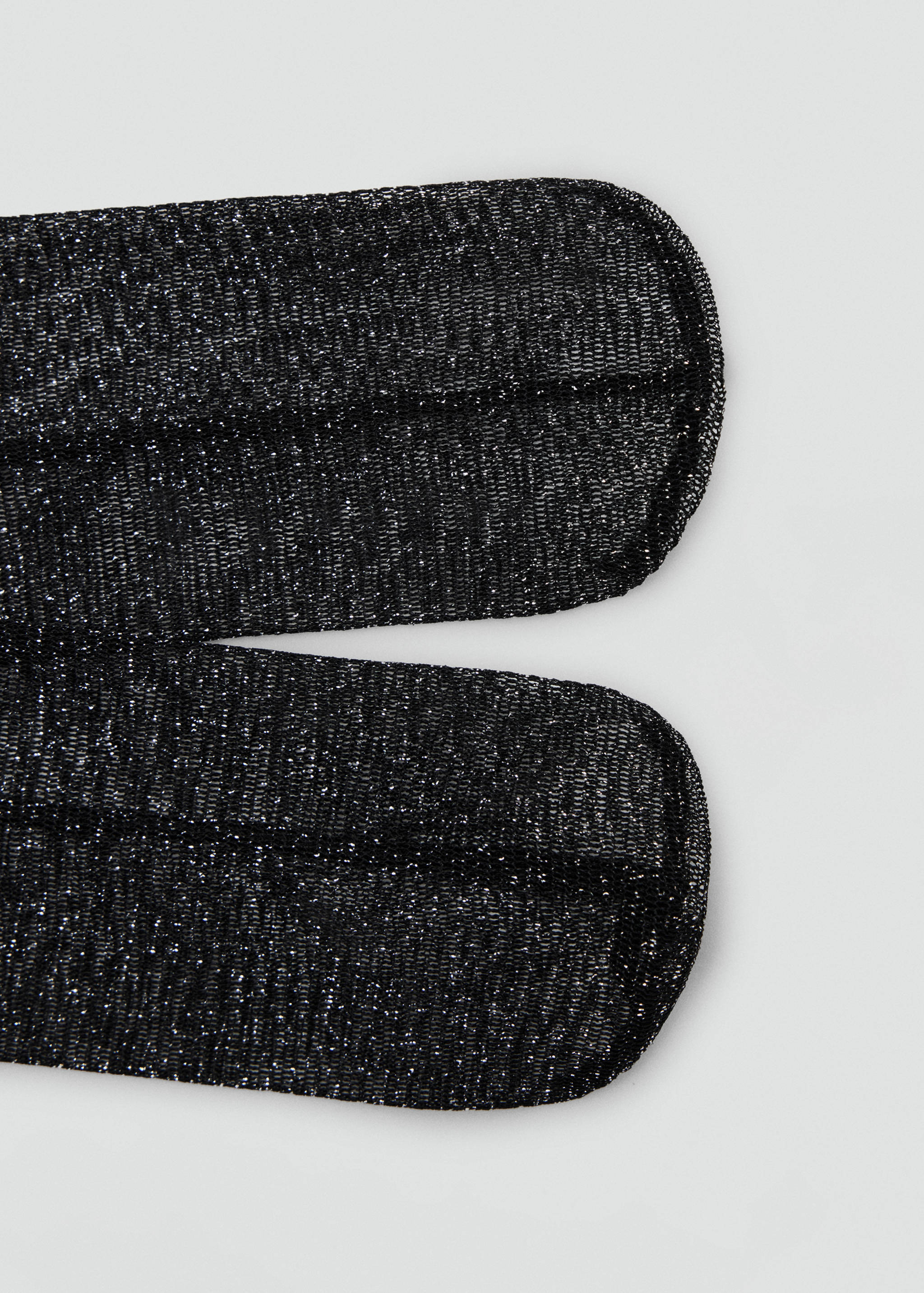 Close-up of black metallic sparkle socks showing the fine glittery knit toe detail.