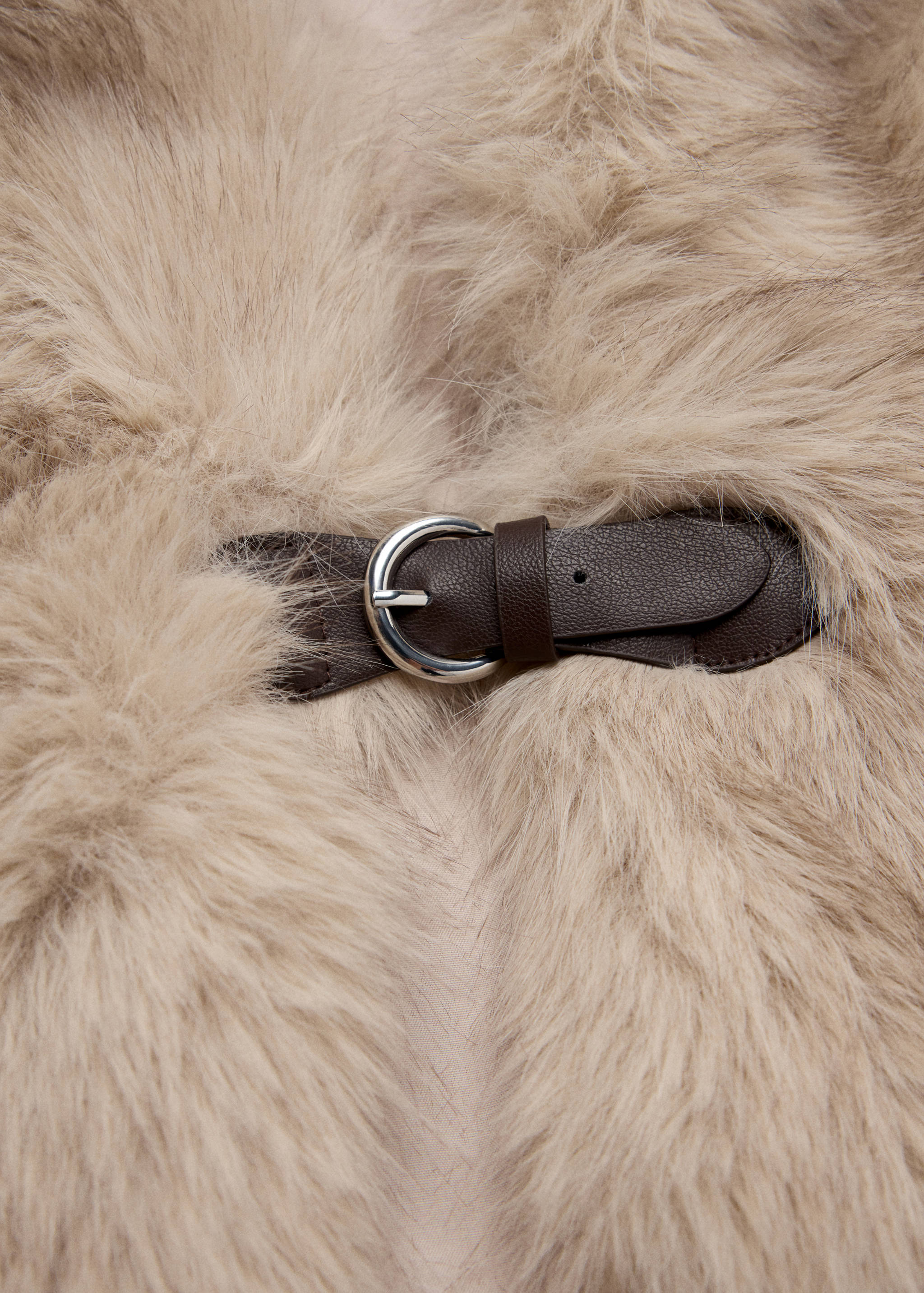 Beige faux-fur hat with a brown strap and silver buckle.