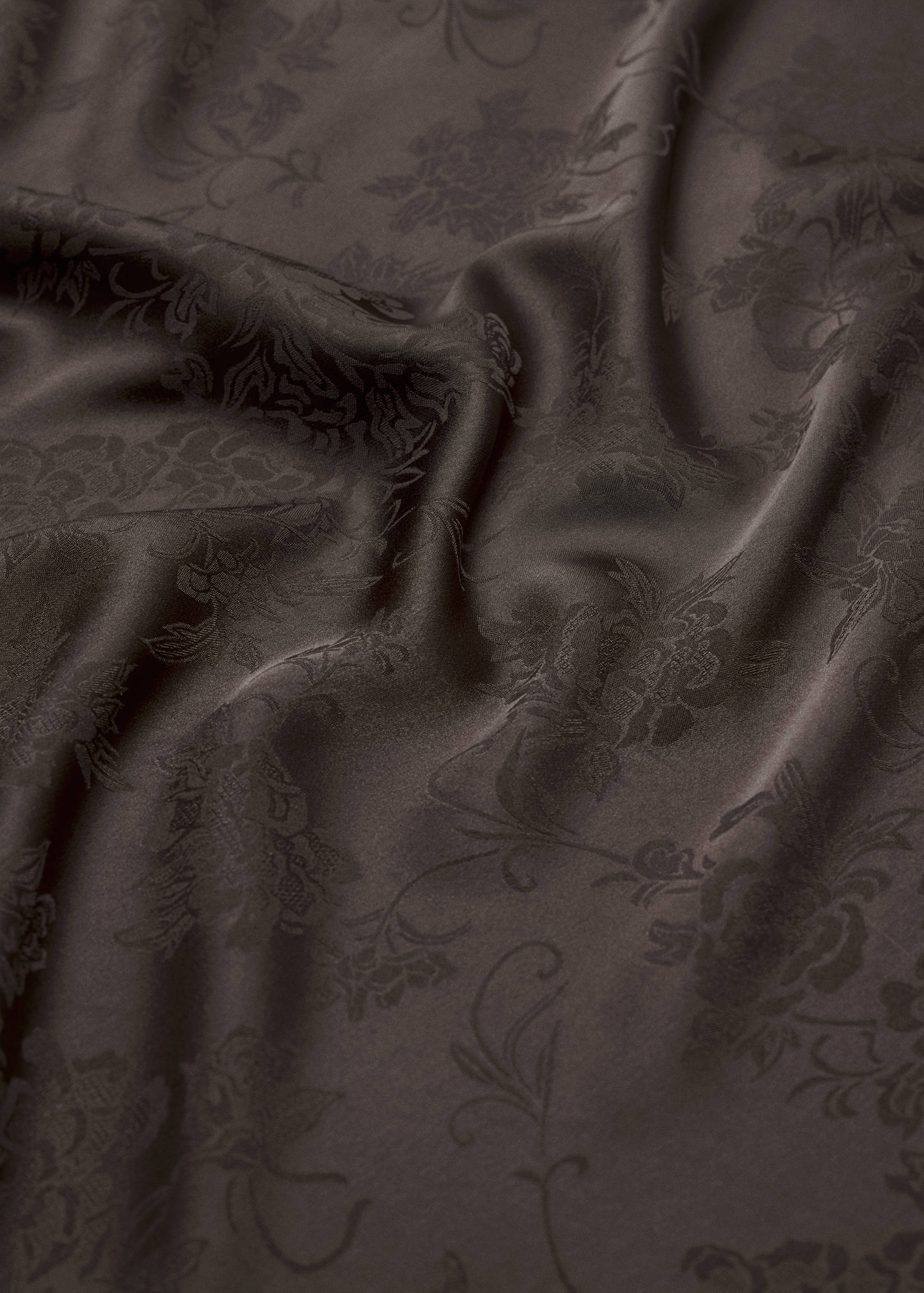 Dark brown scarf in a lustrous fabric with a tonal floral pattern.