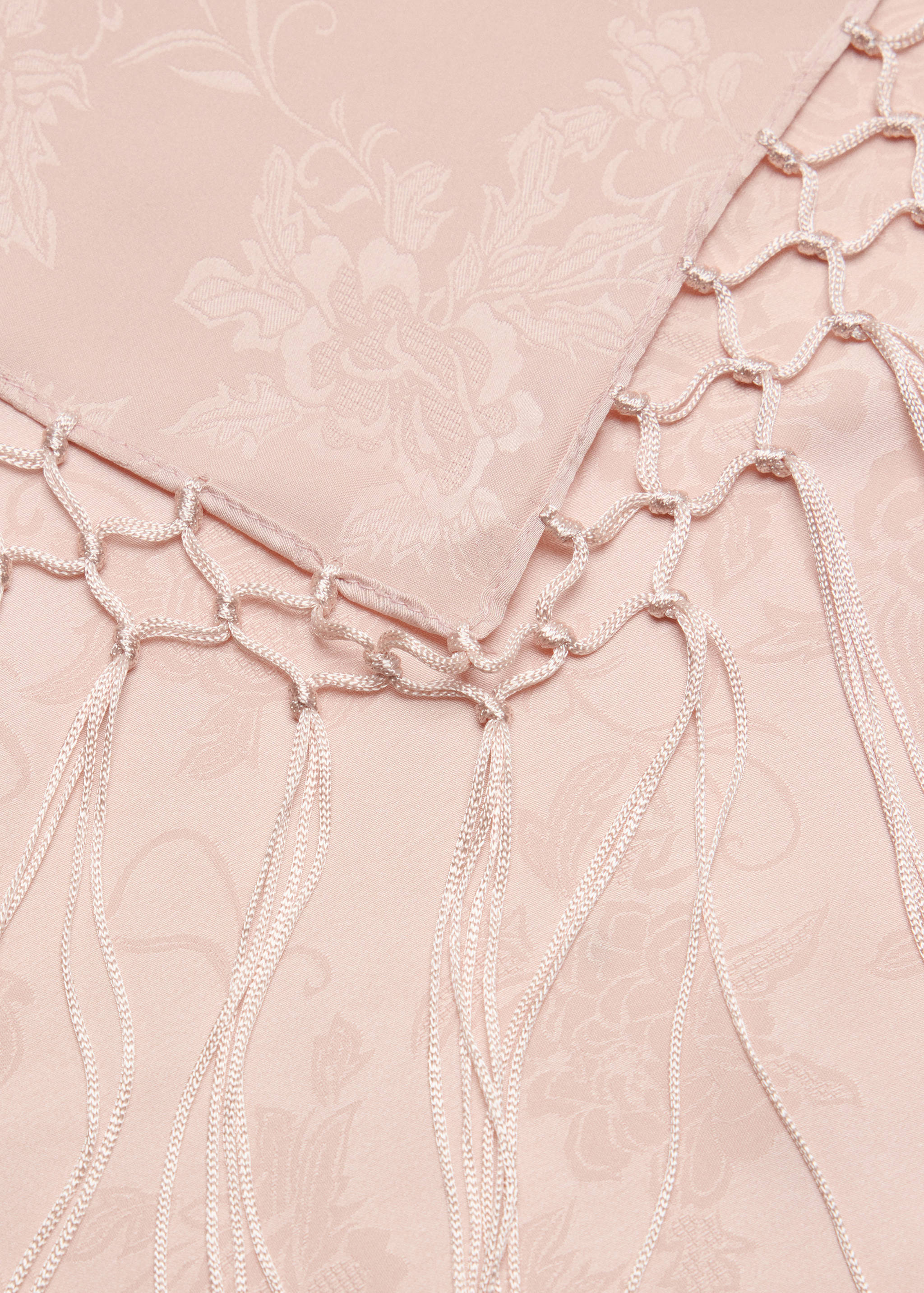 Pale pink scarf with tonal floral jacquard and macramé fringe.