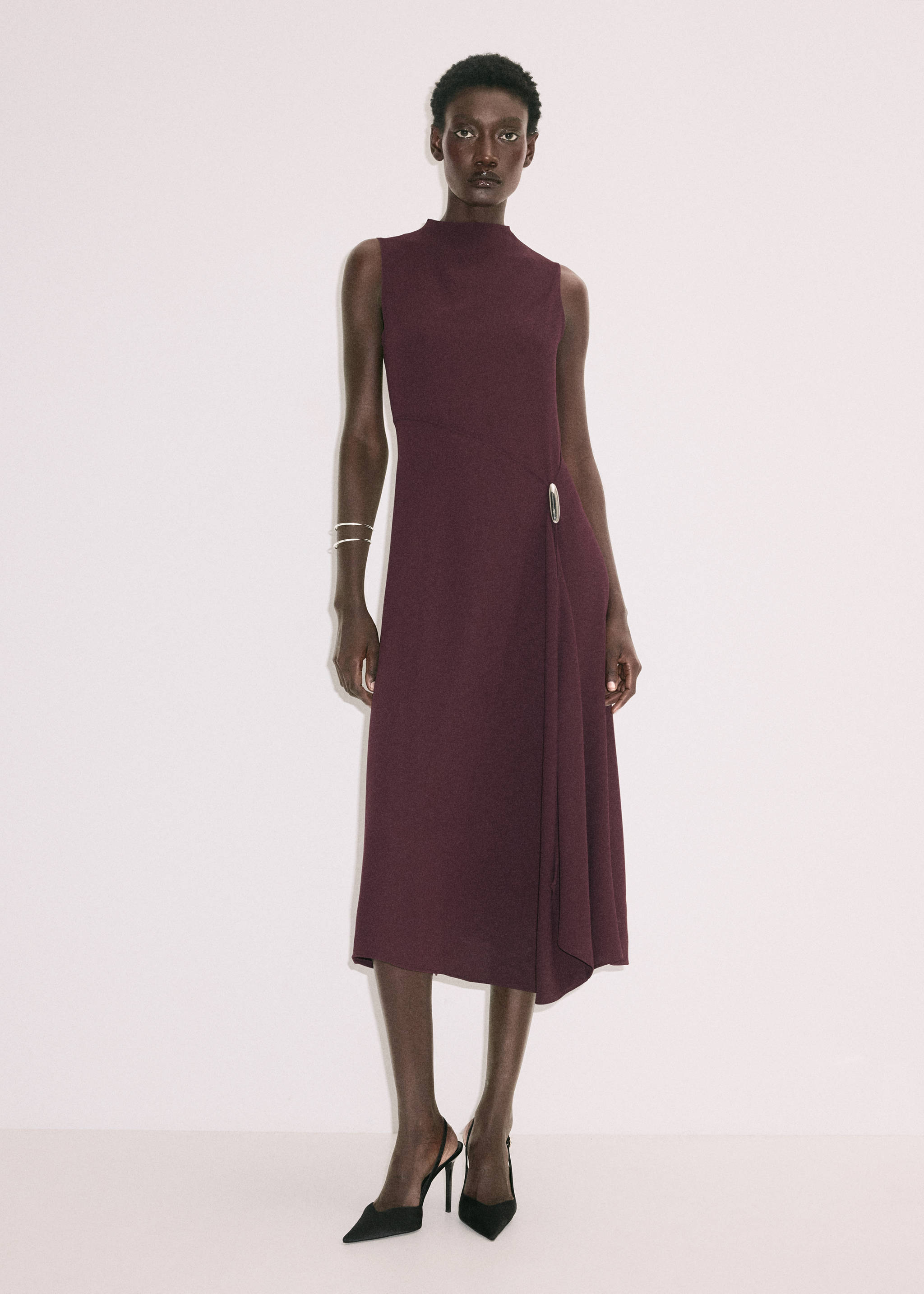 Plum-coloured sleeveless midi dress with mock neck and silver ring detail.