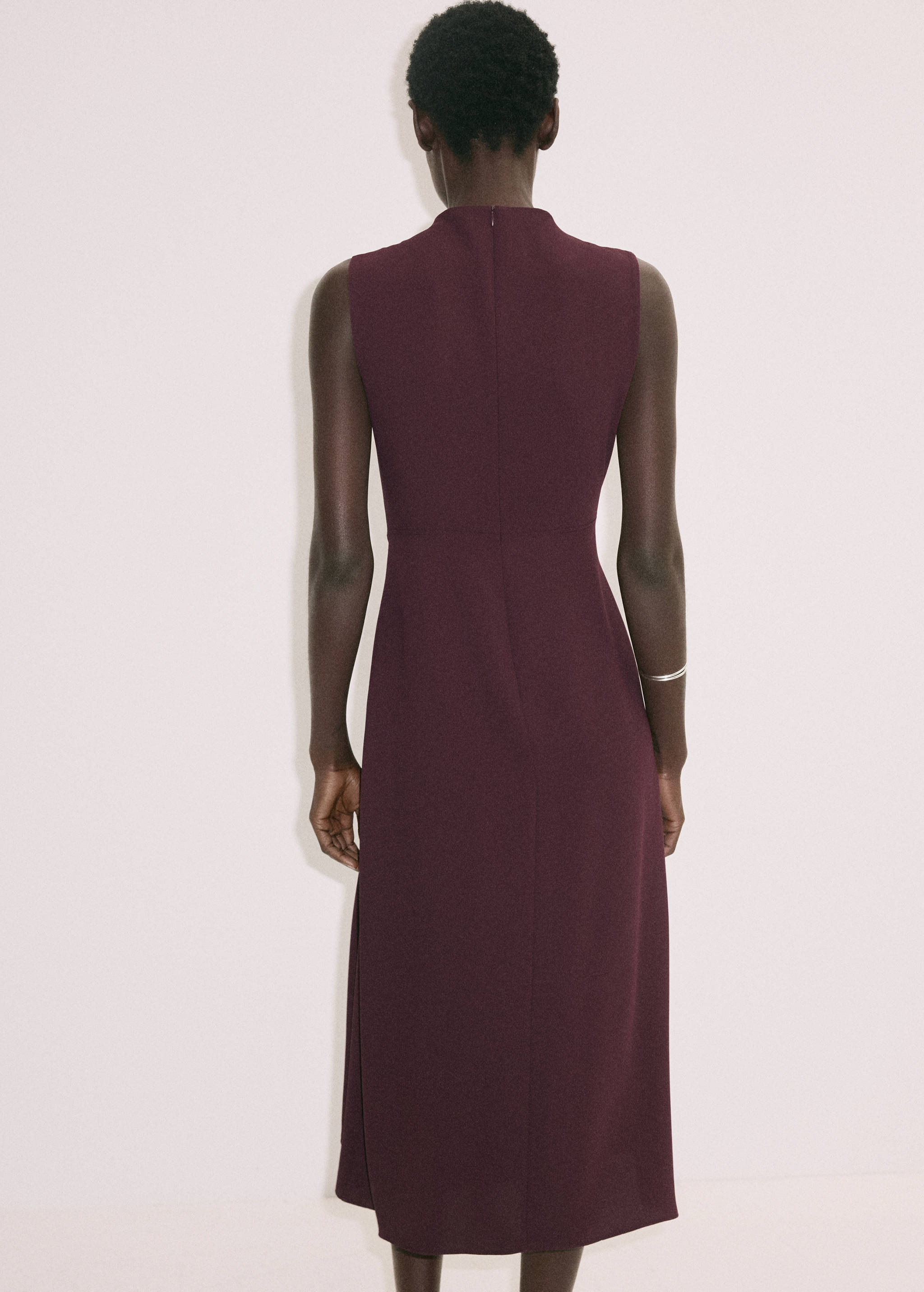 Burgundy sleeveless midi dress with a high collar, back view.