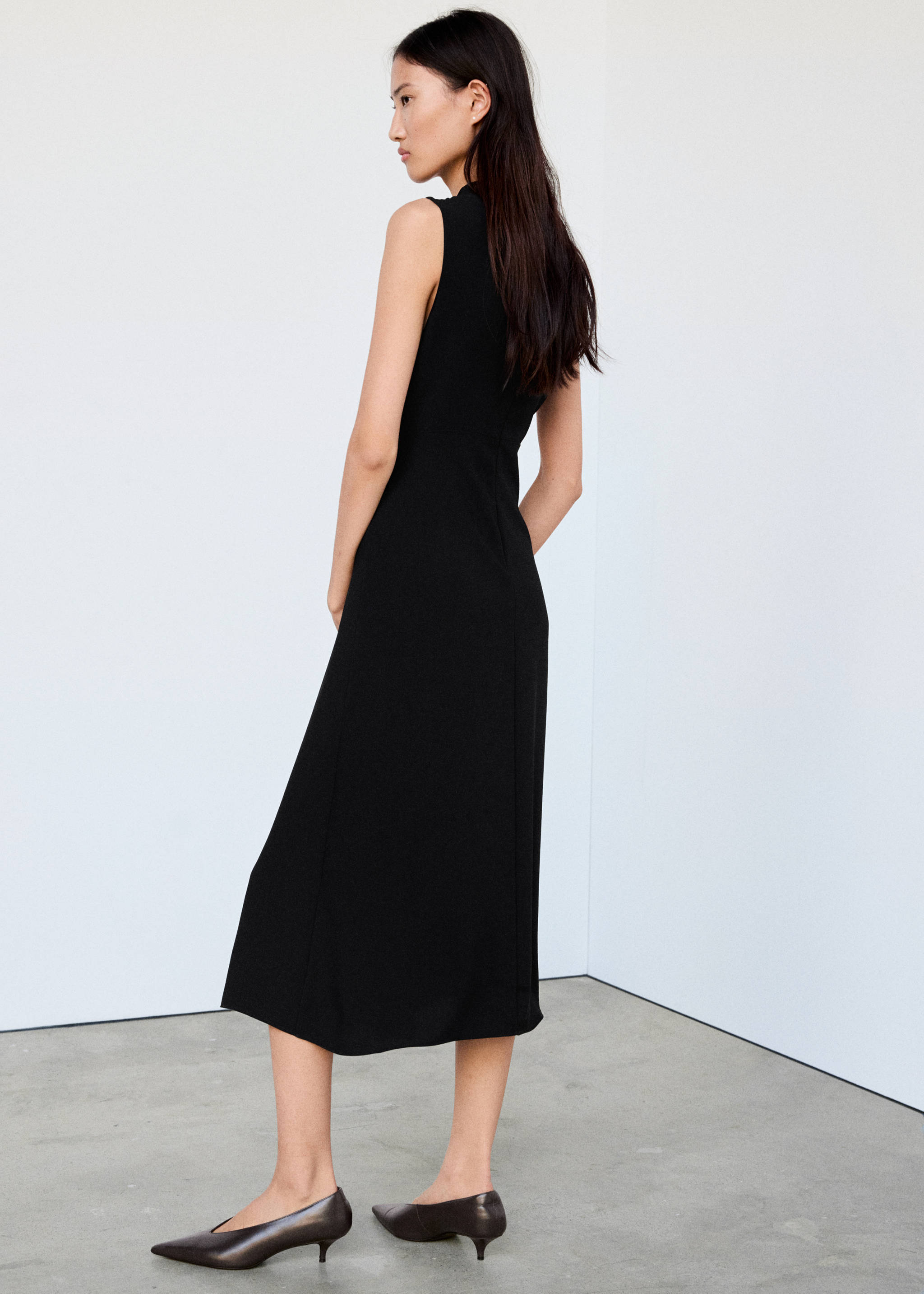 Black sleeveless midi dress, back view.