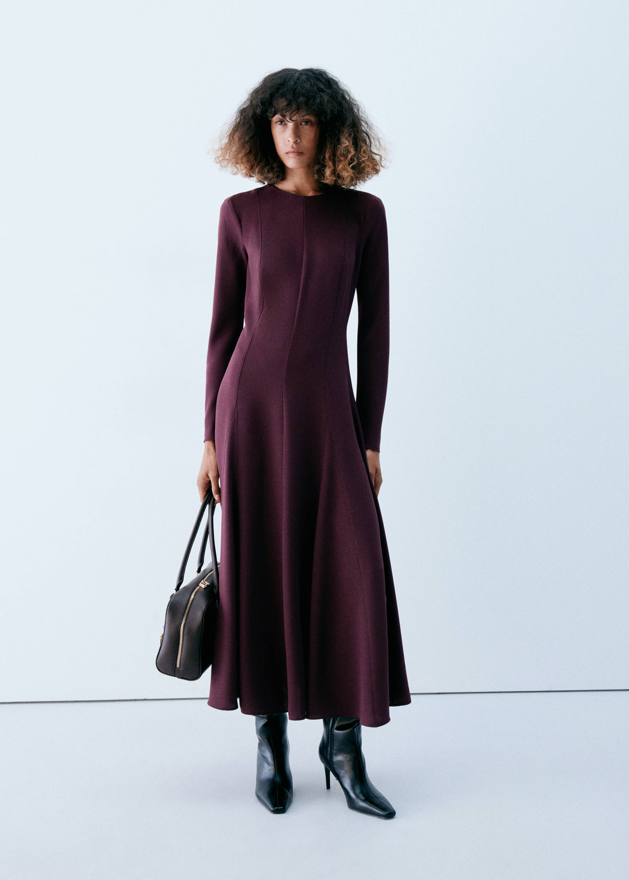 Long-sleeved burgundy knit midi dress with a fitted bodice and flared skirt.