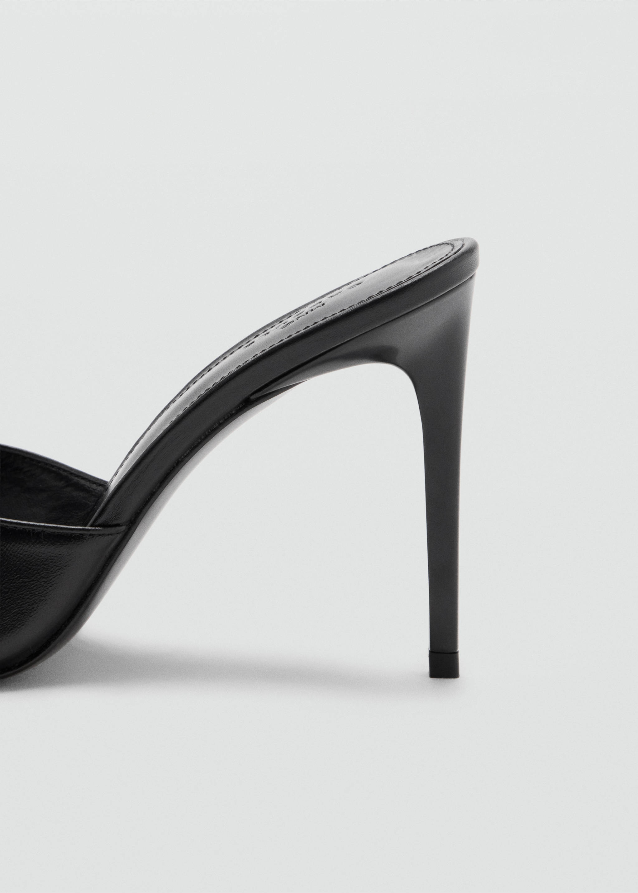 Close-up of a black heeled sandal focusing on the stiletto heel., Black. Ref: 47071481-00.
