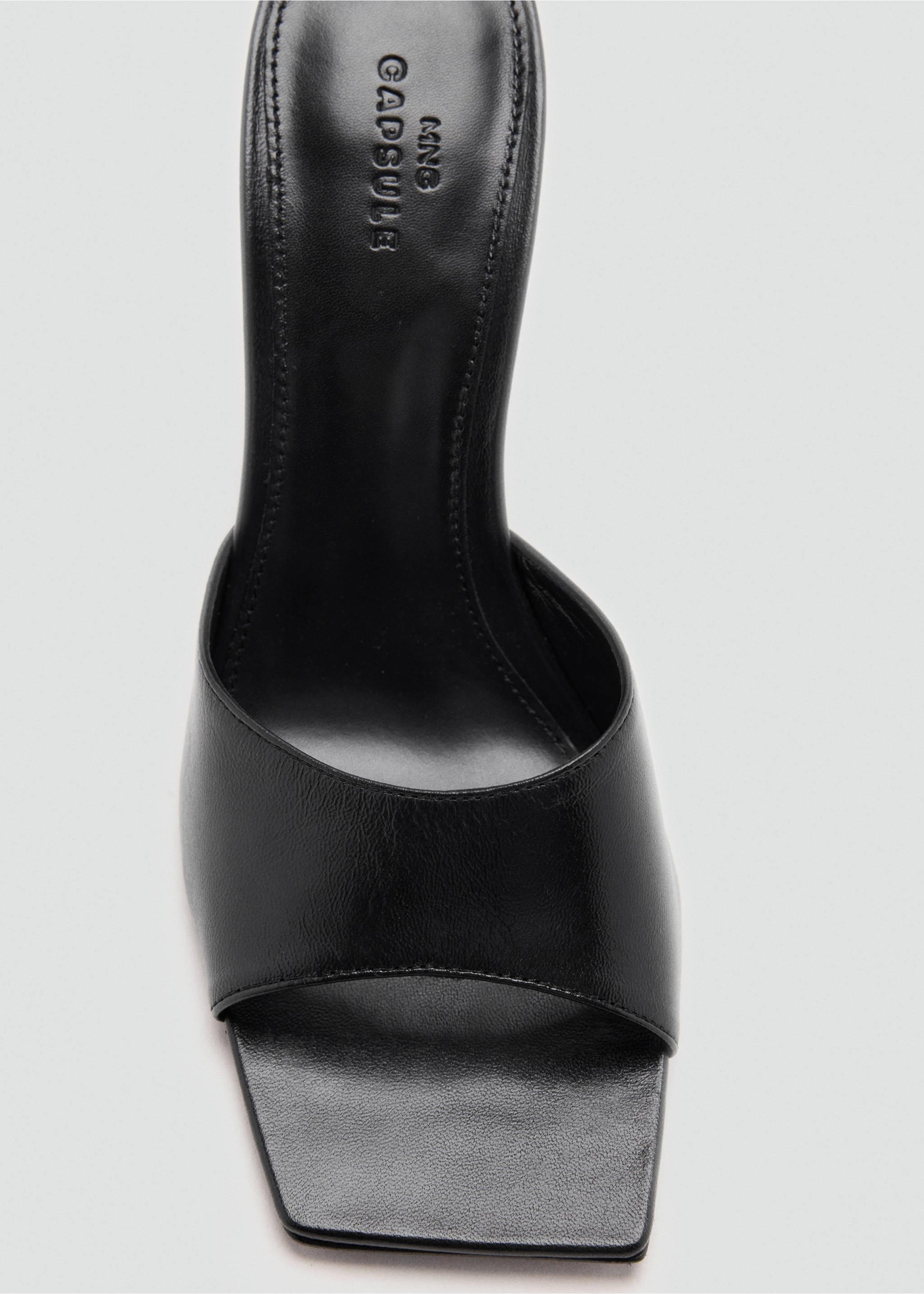 Close-up of a black sandal with a square toe and wide strap., Black. Ref: 47071481-00.