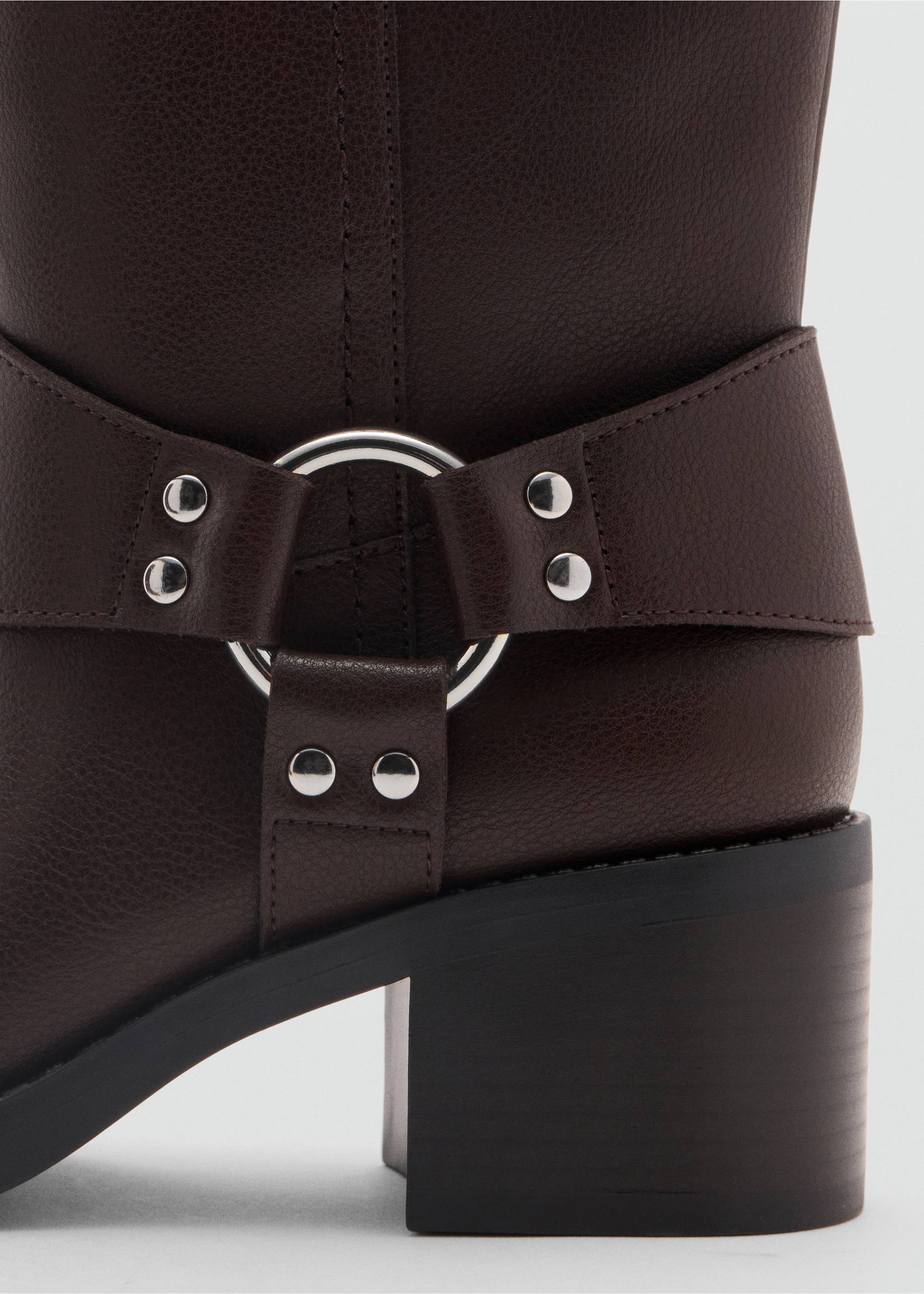 Close-up of a dark brown boot ankle with a silver ring strap and studs., Chocolate. Ref: 47081328-00.