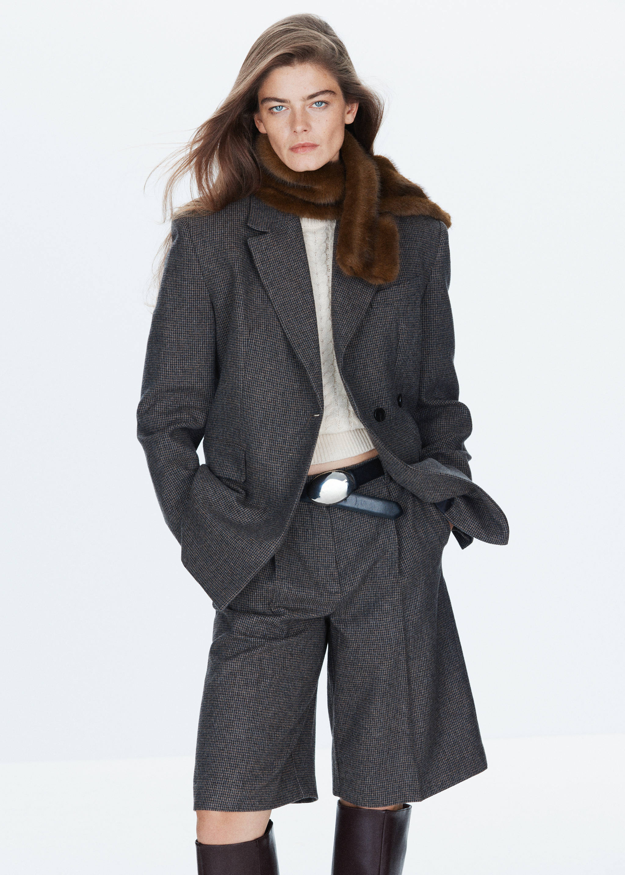 Brown faux-fur scarf worn with a houndstooth blazer and matching shorts.